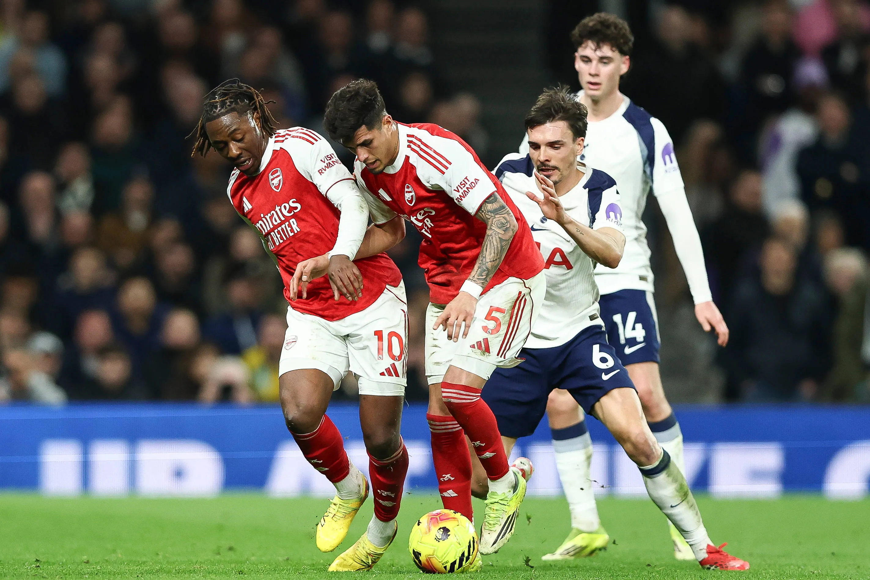 Eberechi Eze and Piero Hincapie block Joao Palhinha during the Tottenham Hotspur v Arsenal Premier League match at the Tottenham Hotspur Stadium