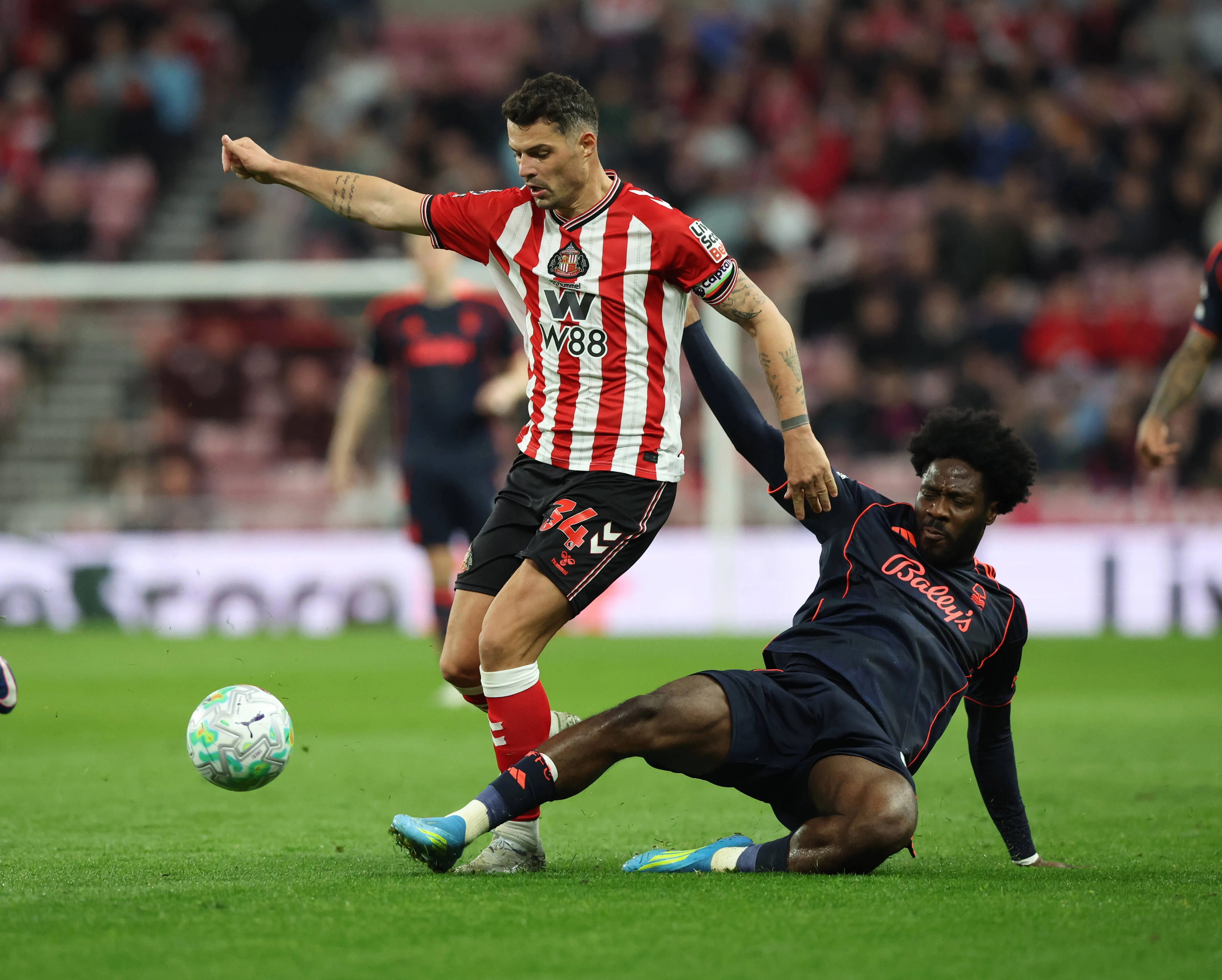 Granit Xhaka of Sunderland in action with Ola Aina