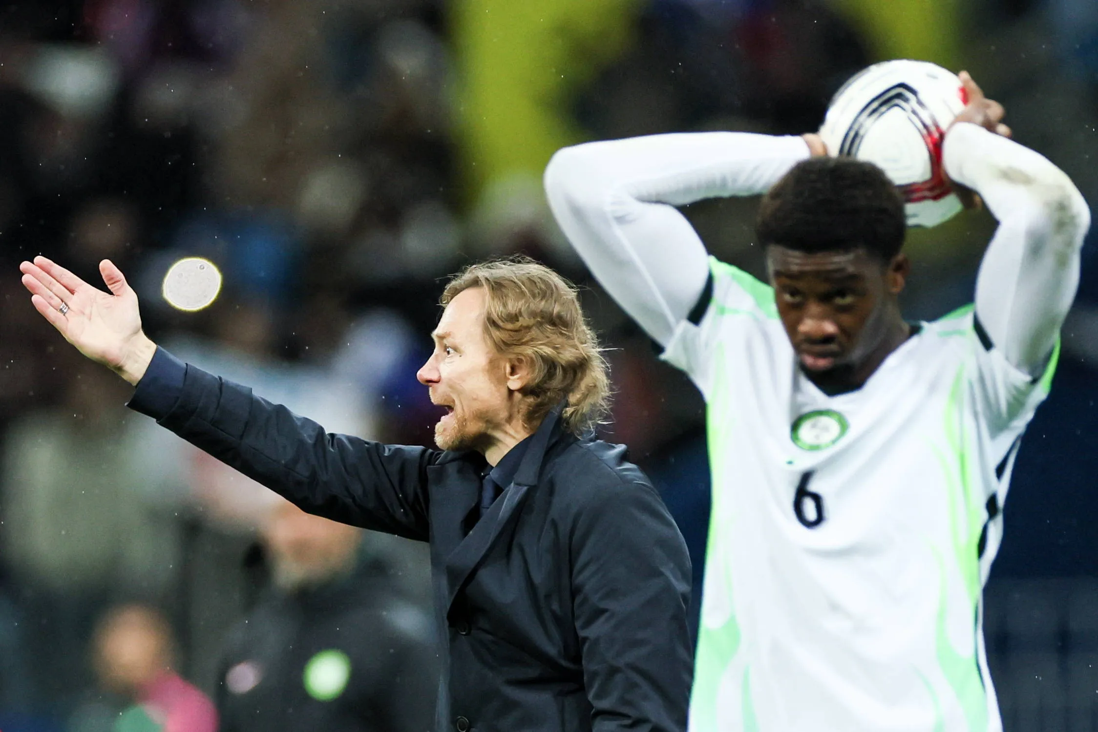 Russian headcoach, Valery Karpin gestures in the background beside Emmanuel Fernandez