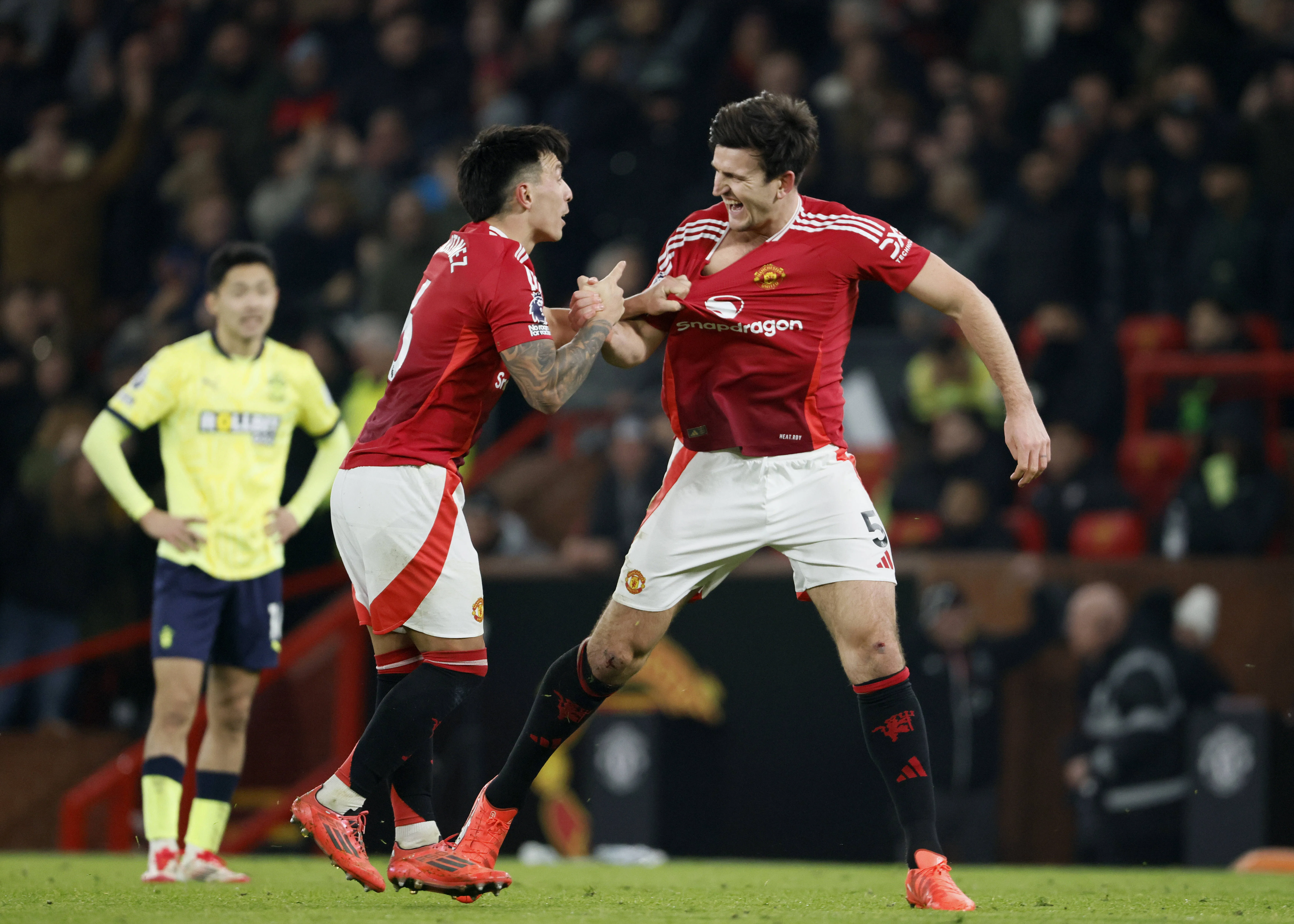 Harry Maguire and Lisandro Martinez celebrate during the Premier League match between Manchester United FC and Southampton FC.
