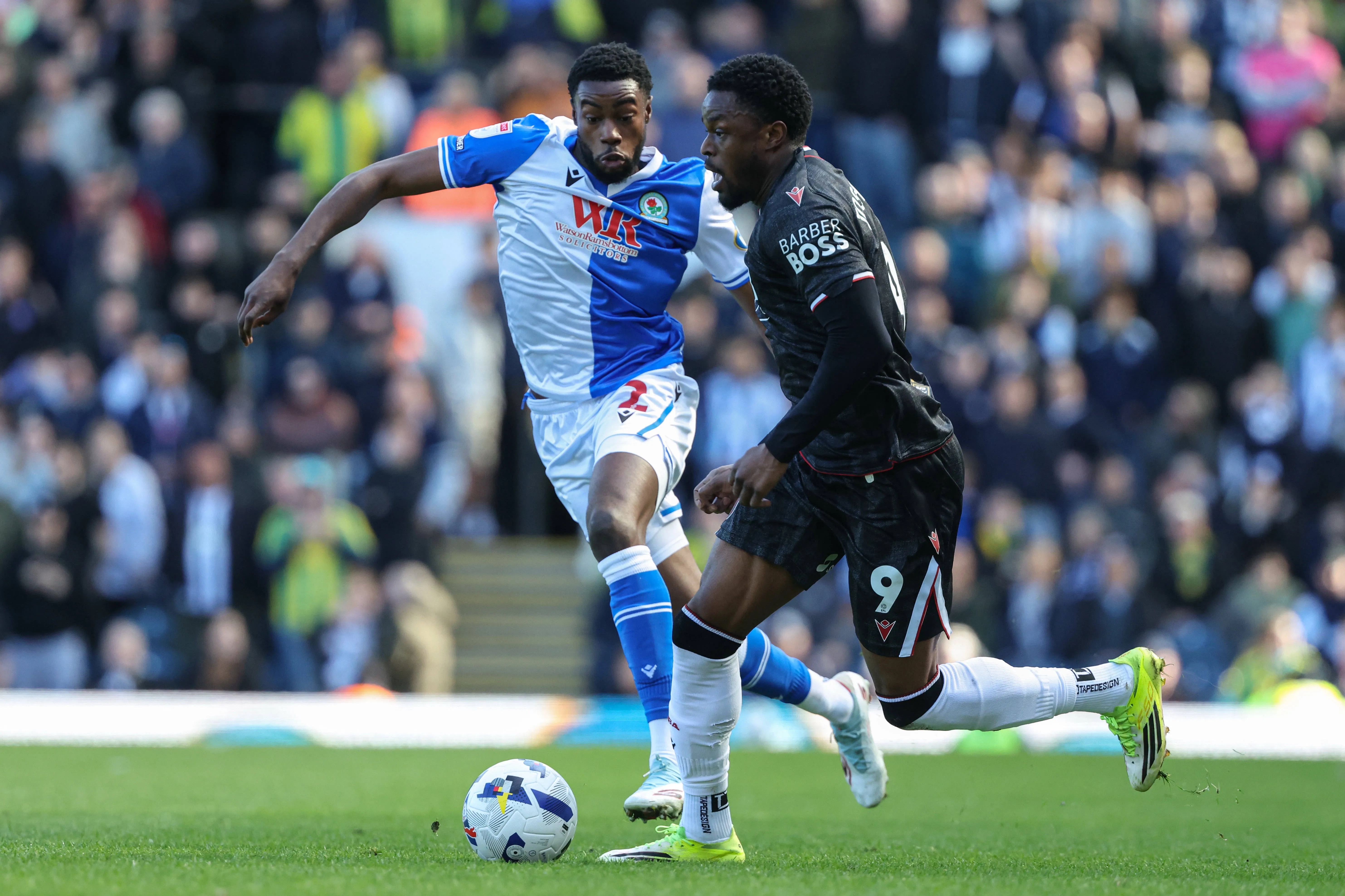 Josh Maja of West Bromwich Albion runs with the ball with Ryan Alebiosu of Blackburn Rovers