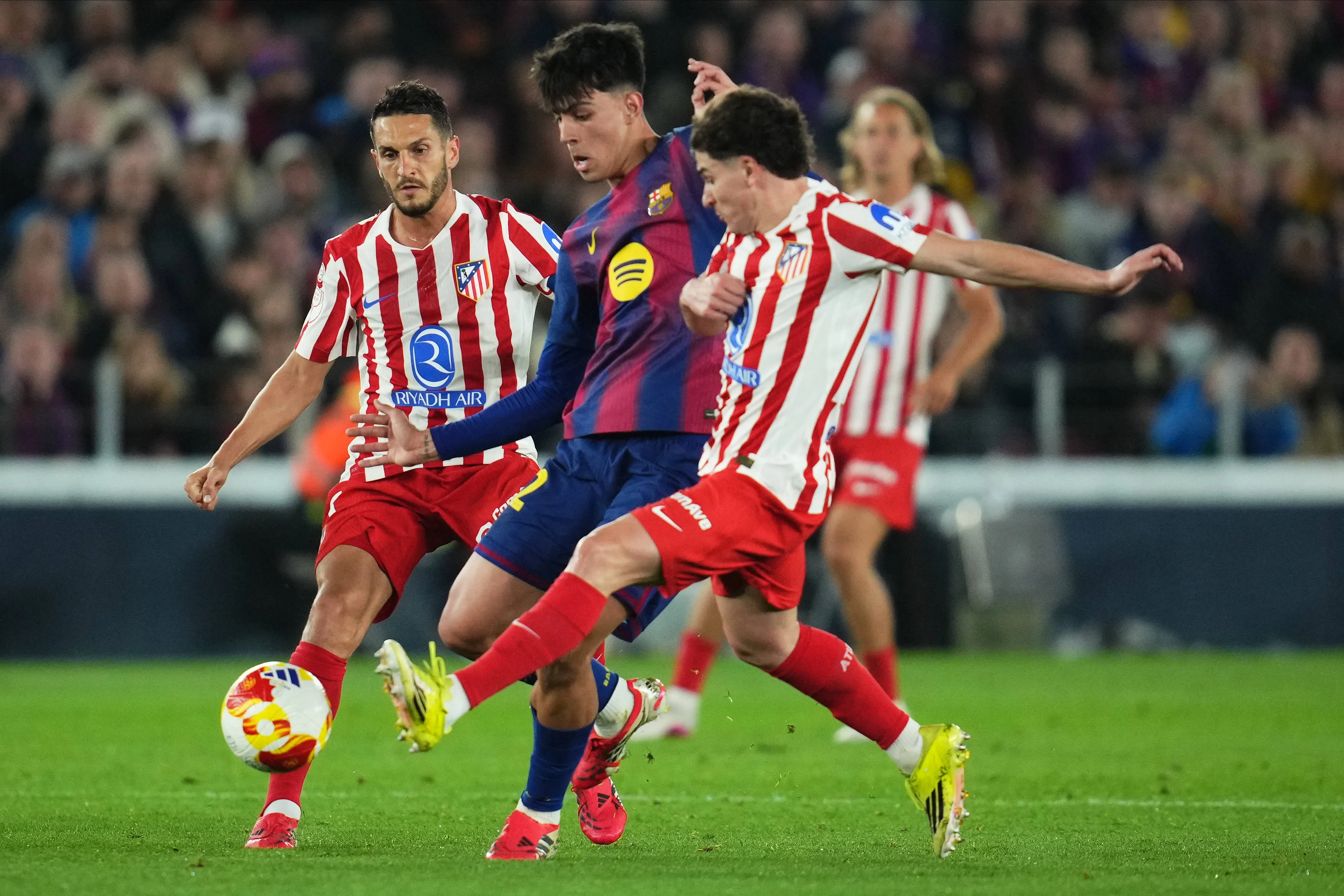 Marc Bernal of FC Barcelona and Julian Alvarez of Atletico de Madrid
