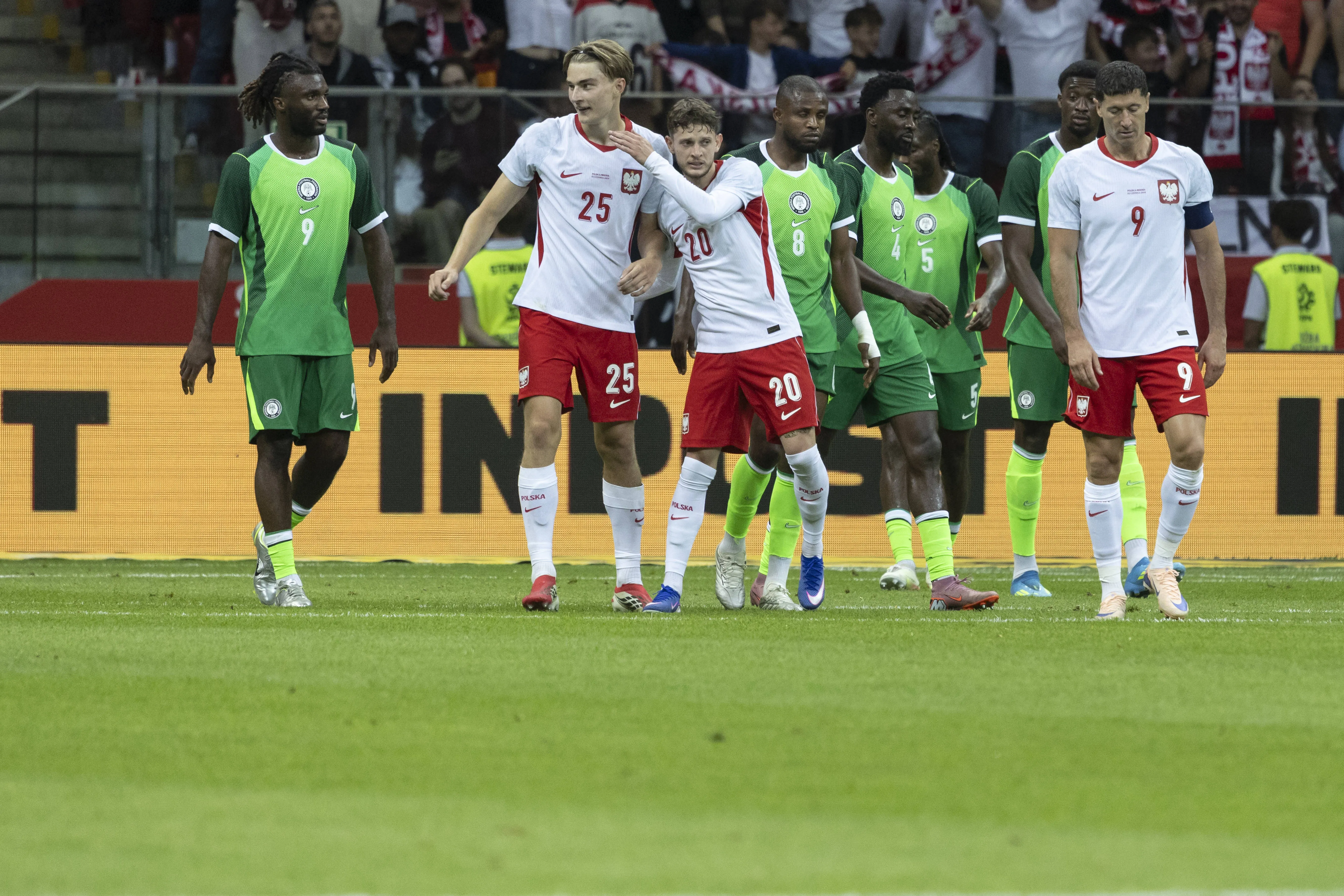Kacper Potulski and Sebastian Szymanski celebrate against Nigeria