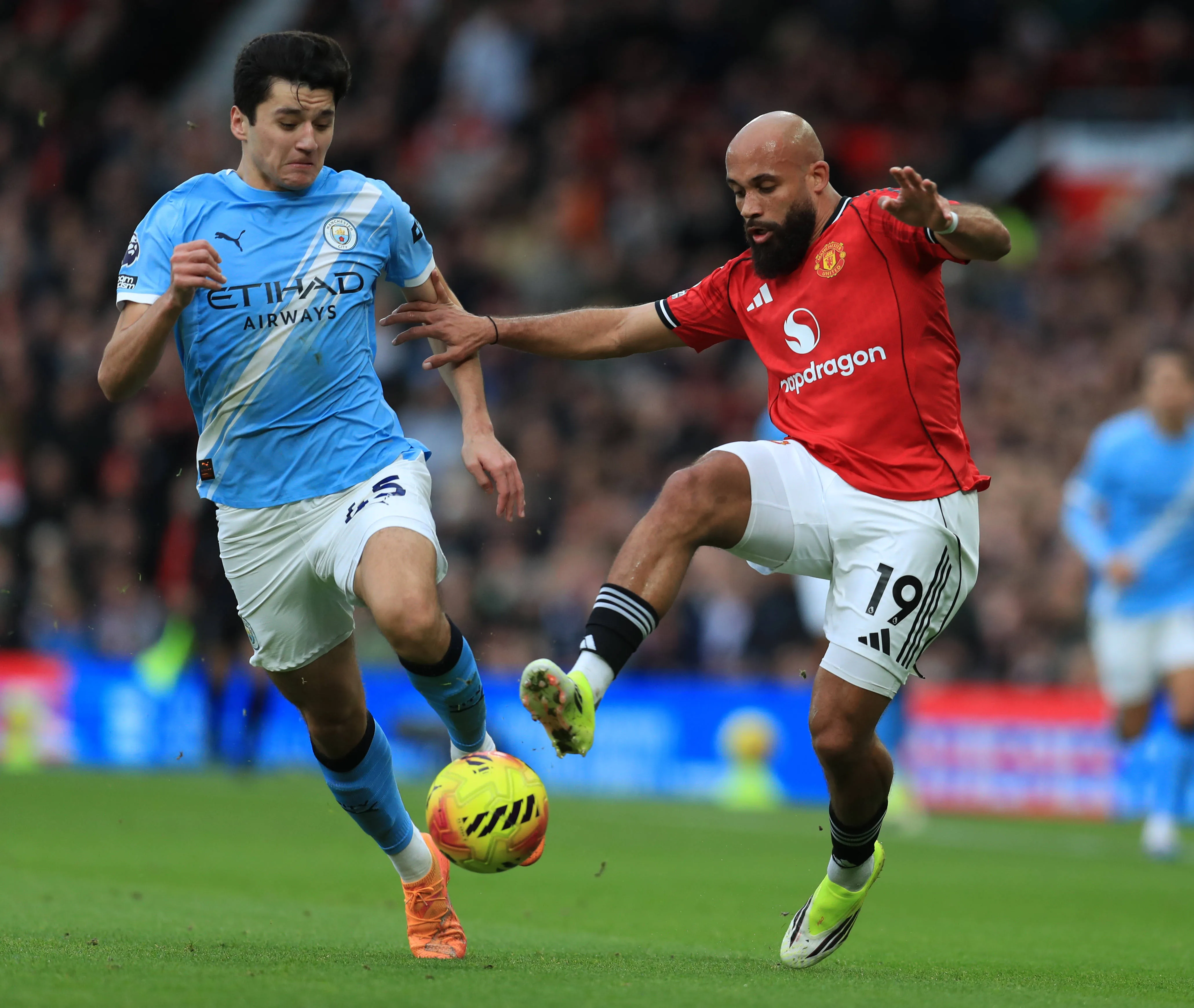 Bryan Mbuemo of Manchester United takes on Abdukodir Khusanov of Manchester City