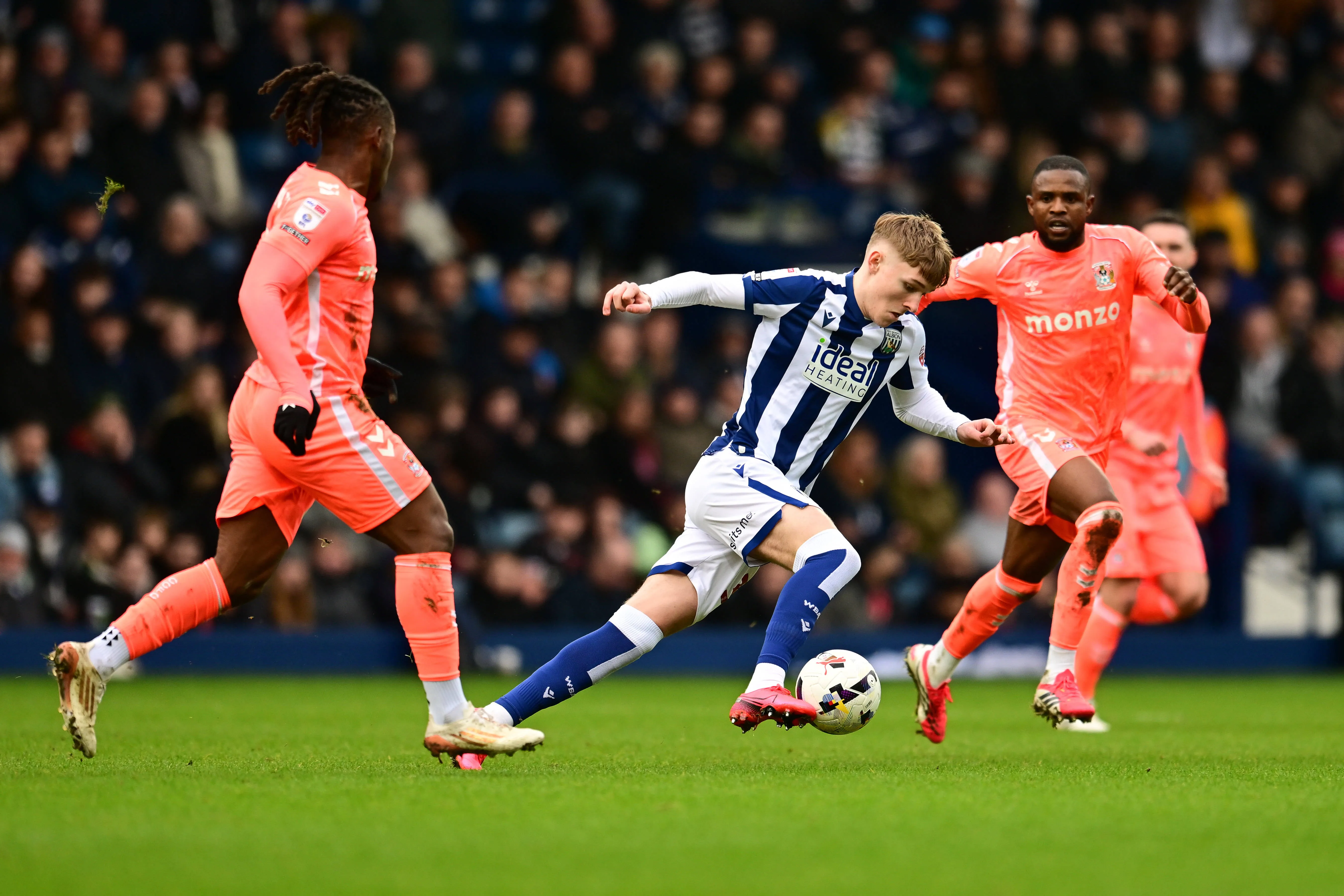 Ollie Bostock sprints forward with the ball under pressure from Frank Onyeka during the EFL Sky Bet Championship match between West Bromwich Albion and Coventry City at The Hawthorns