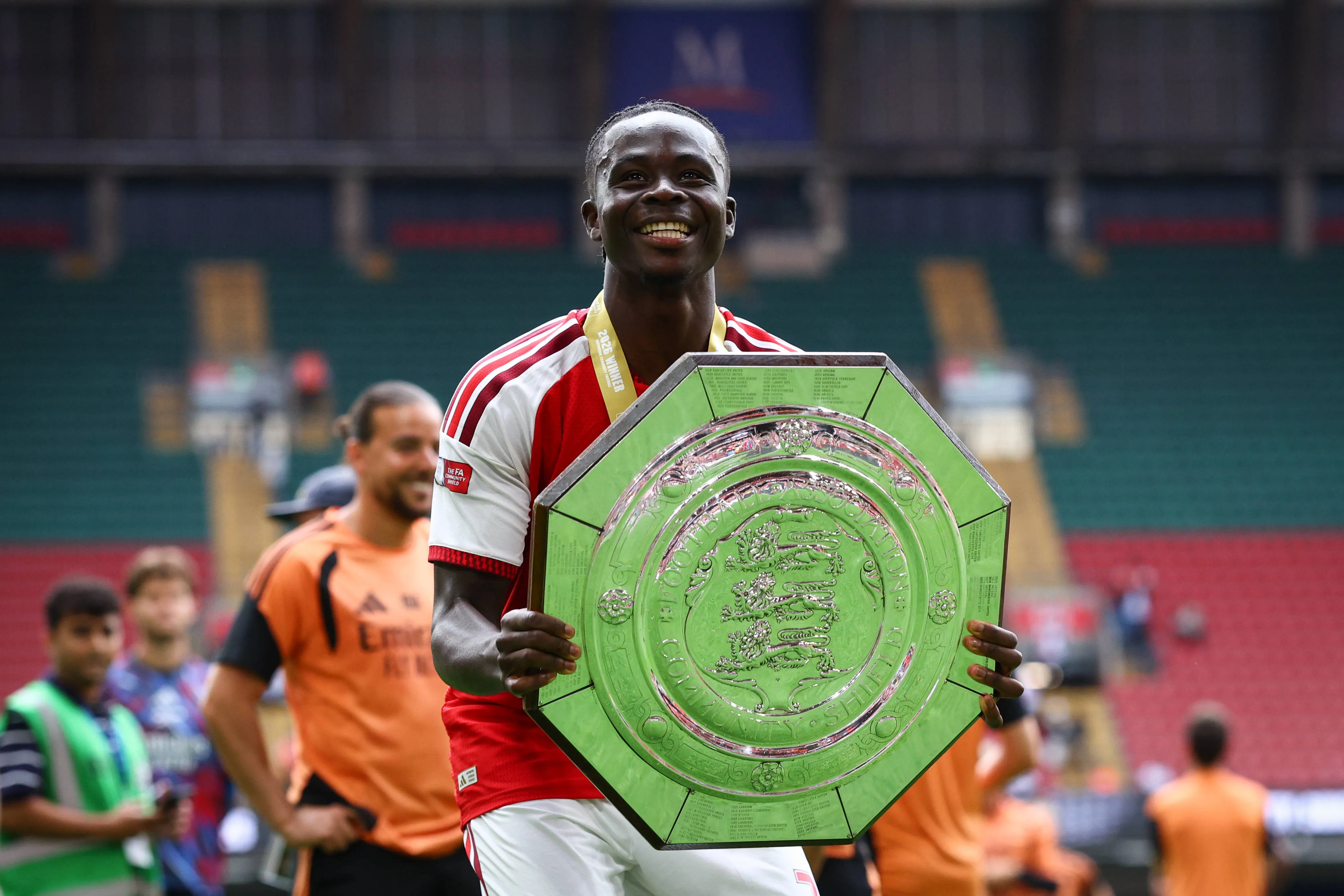 Bukayo Saka of Arsenal celebrates with the Community Shield trophy