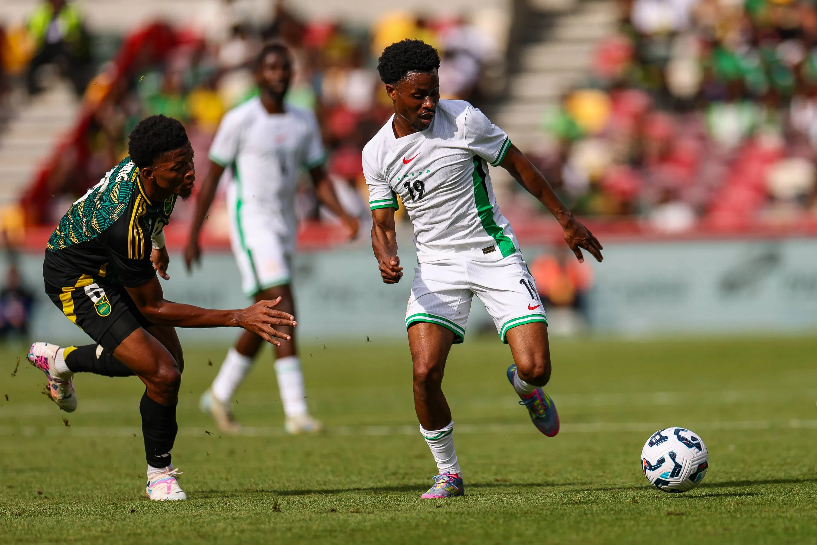 Jamaica defender Richard King and Super Eagles Nathan Tella