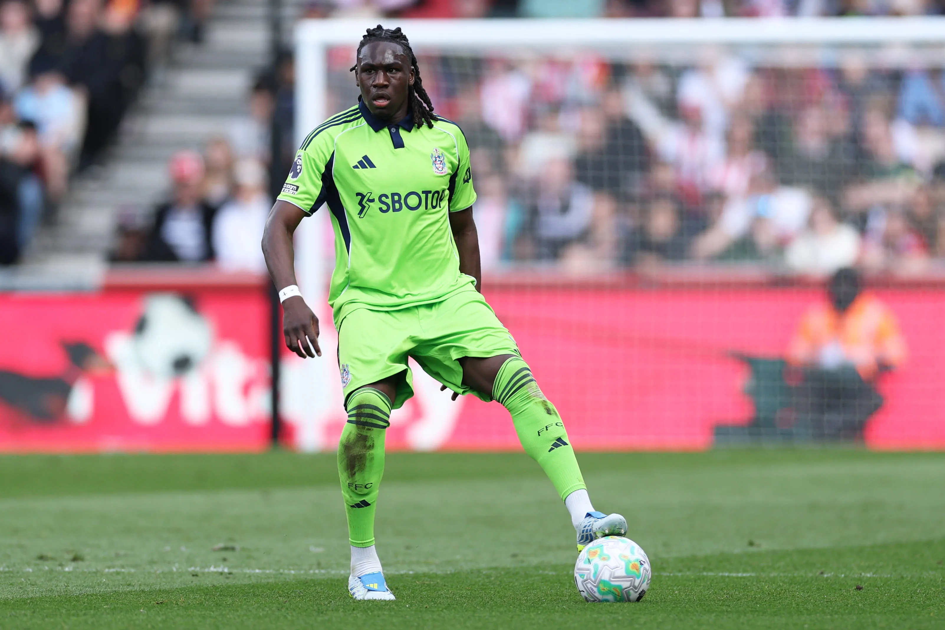 Calvin Bassey of Fulham controls the ball during the Premier League match between Brentford and Fulham at the Gtech Community Stadium in Brentford, United Kingdom, on April 18, 2026