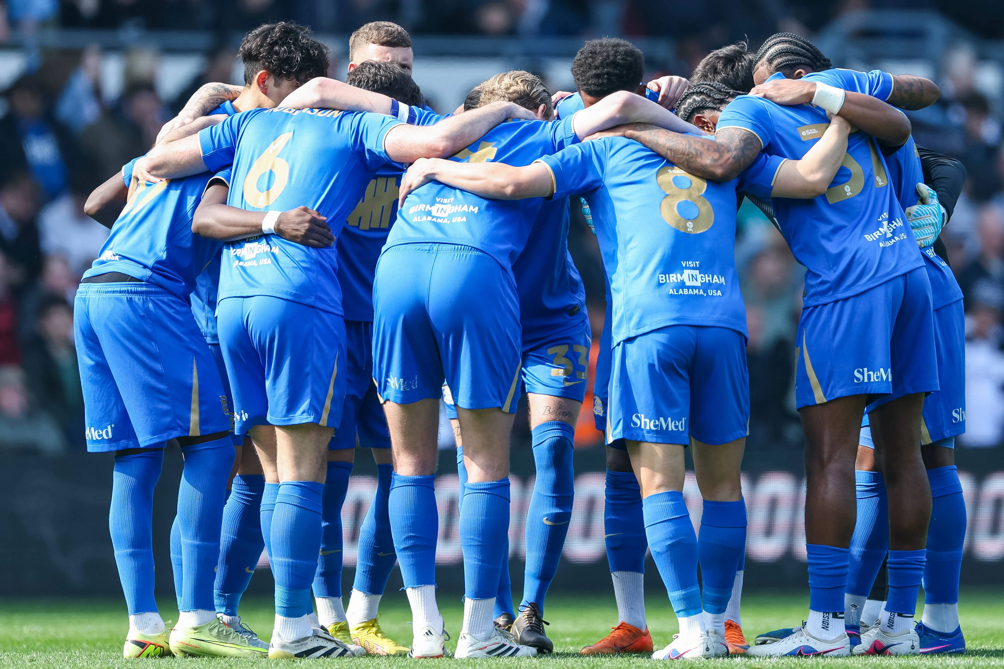 Birmingham City team huddles at kick-off