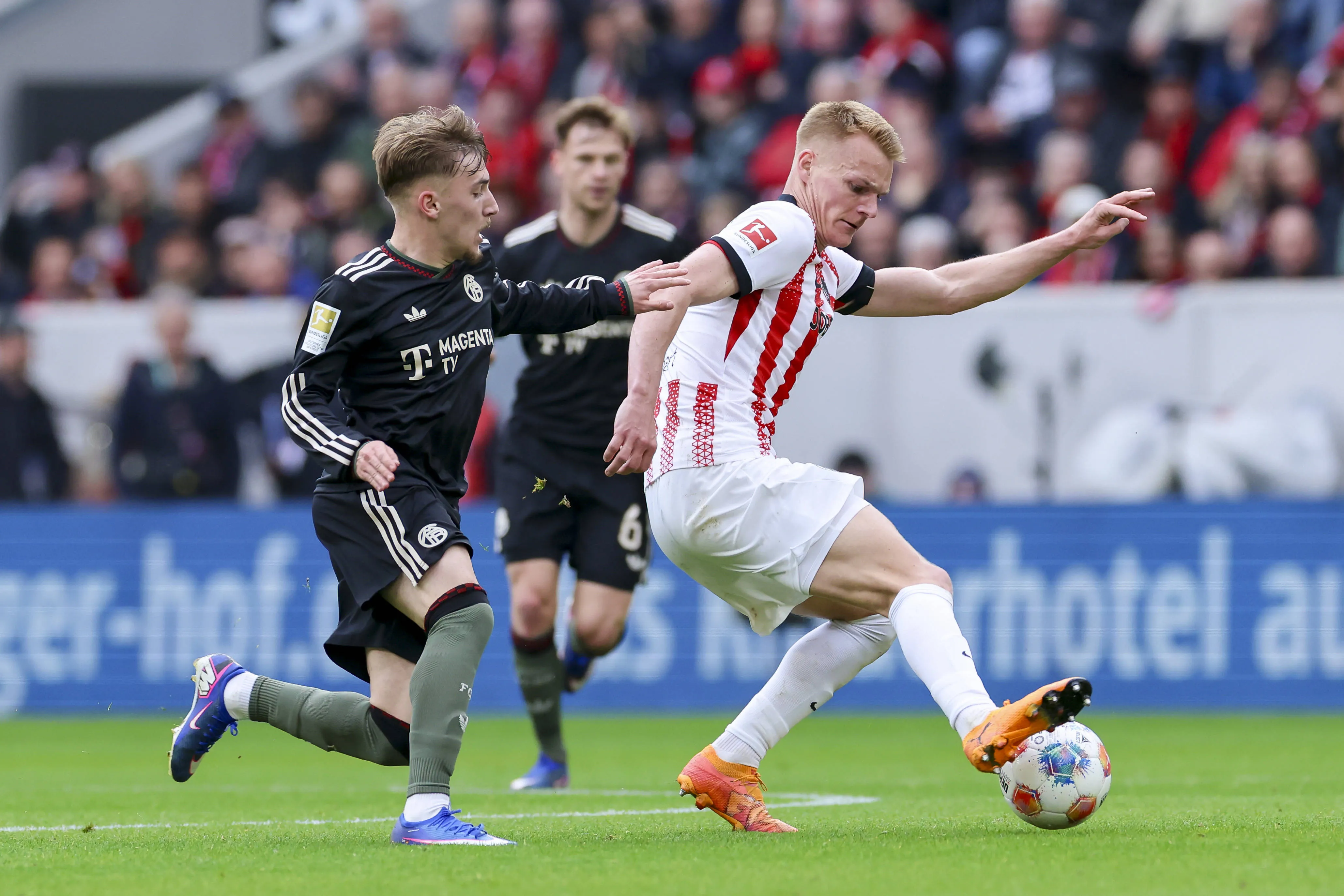 Lennart Karl and Philipp Lienhart battle in SC Freiburg vs Bayern