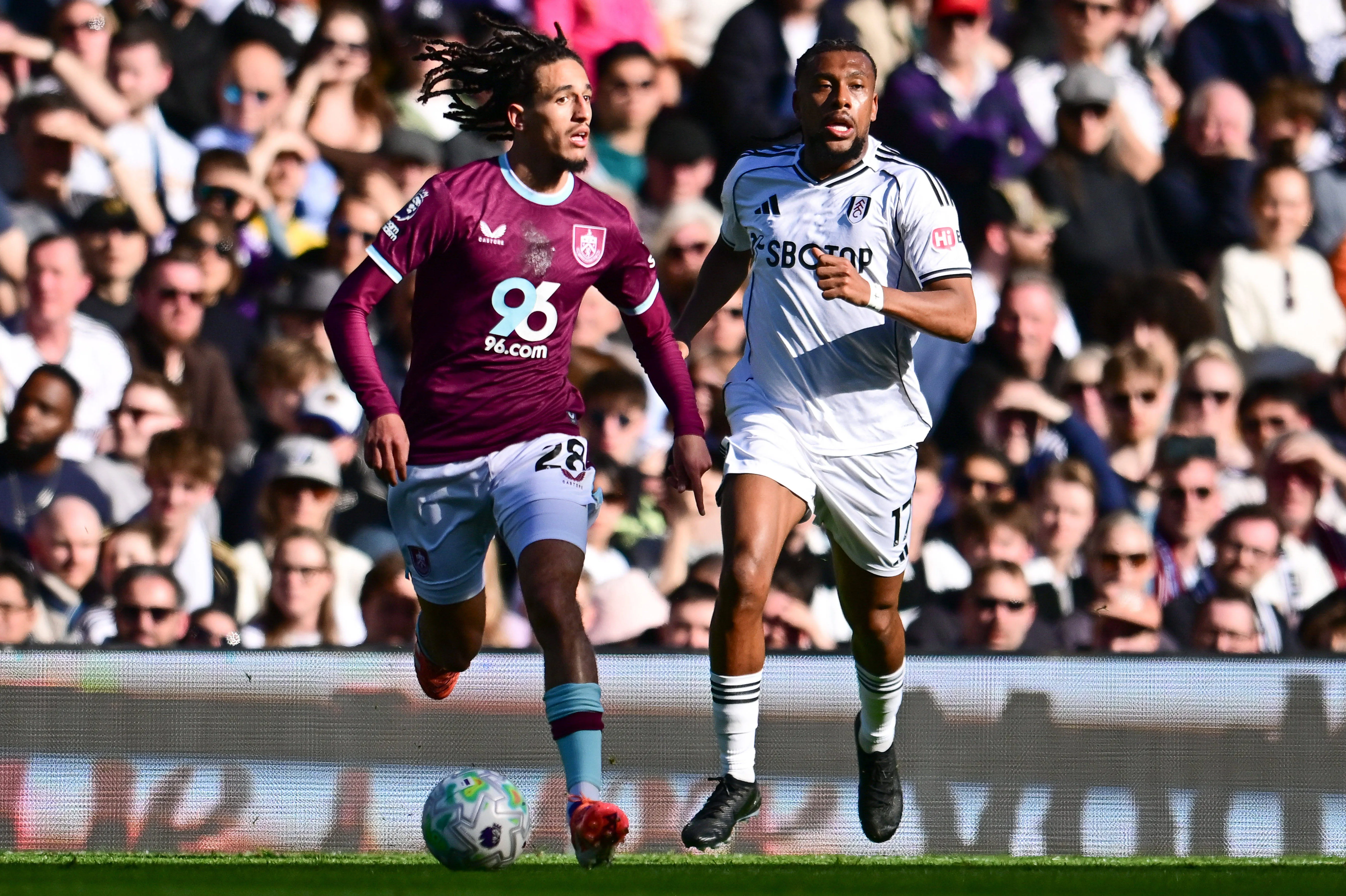 Hannibal Mejbri under pressure from Fulham forward Alex Iwobi