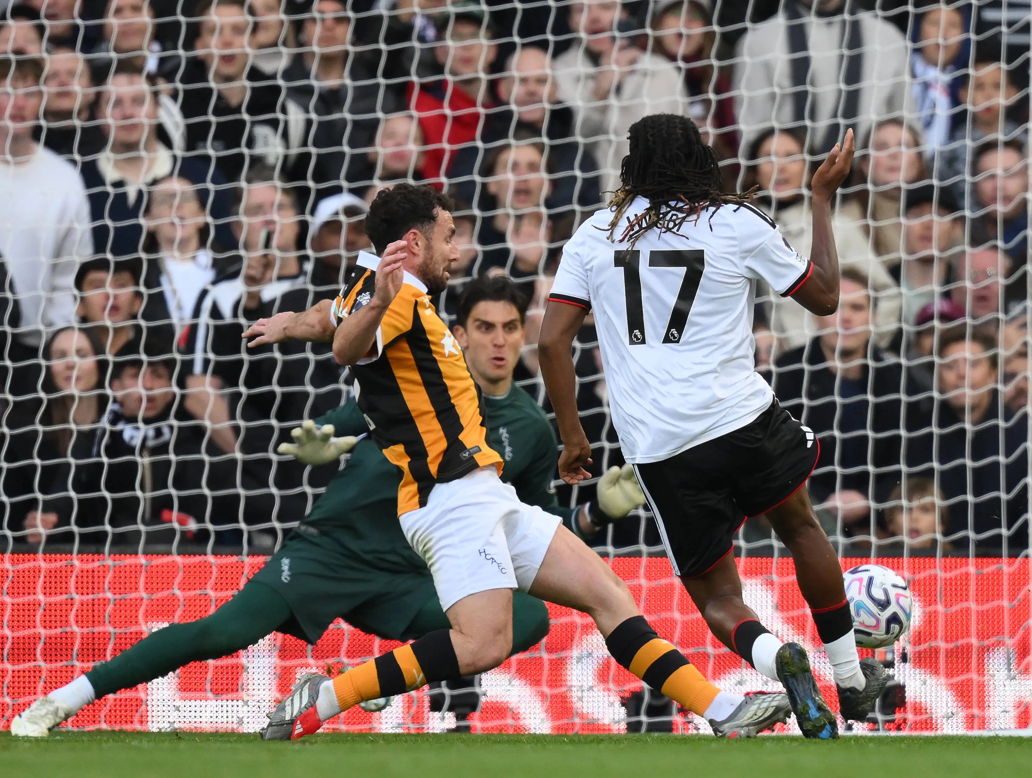 Fulham's Alex Iwobi sees his goal bound shot saved by Konstantinos Tzolakis