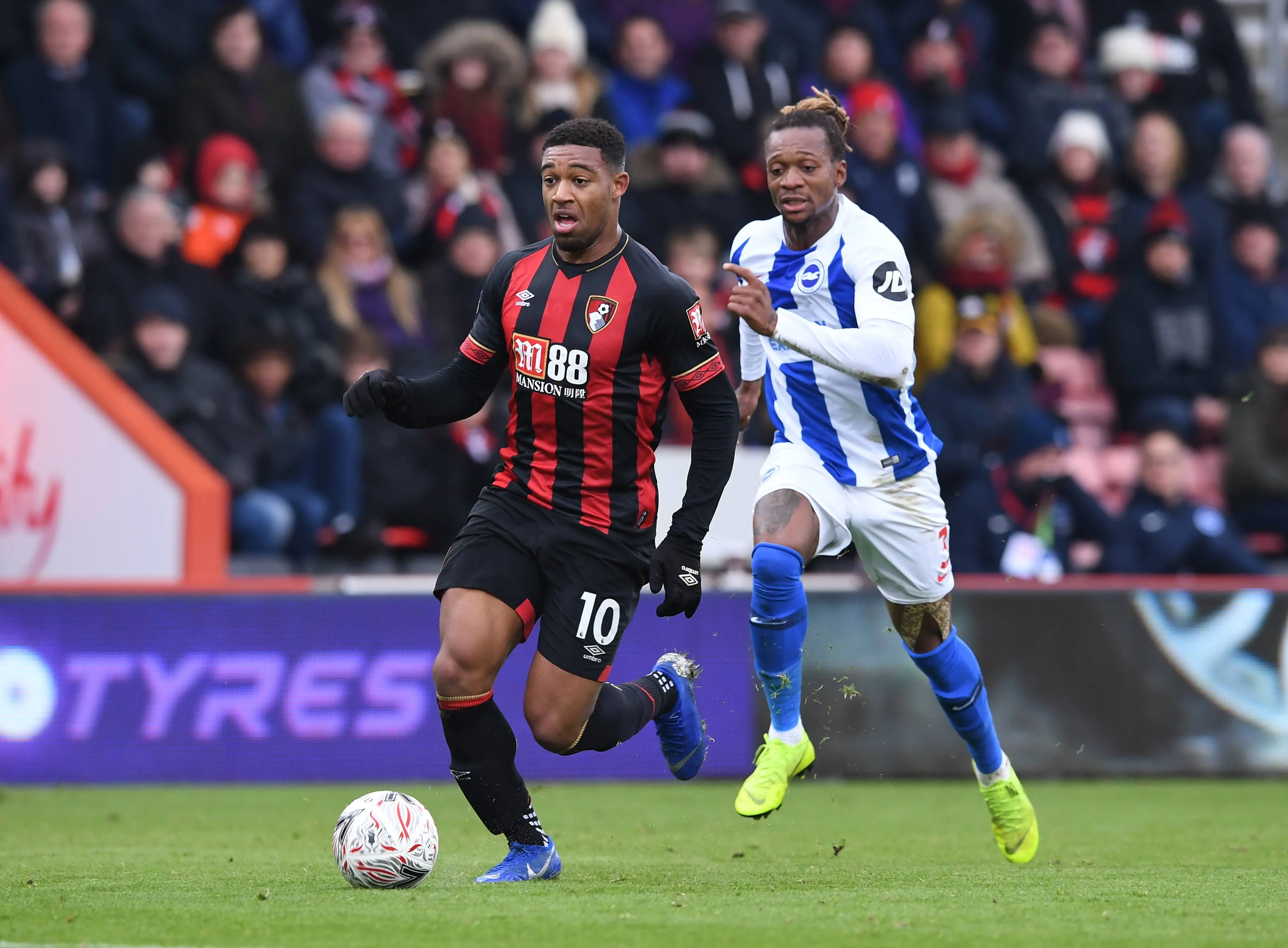Dale Stephens of Brighton tackles Jordon Ibe of Bournemouth brings the ball forward pursued by Gaetan Bong of Brighton