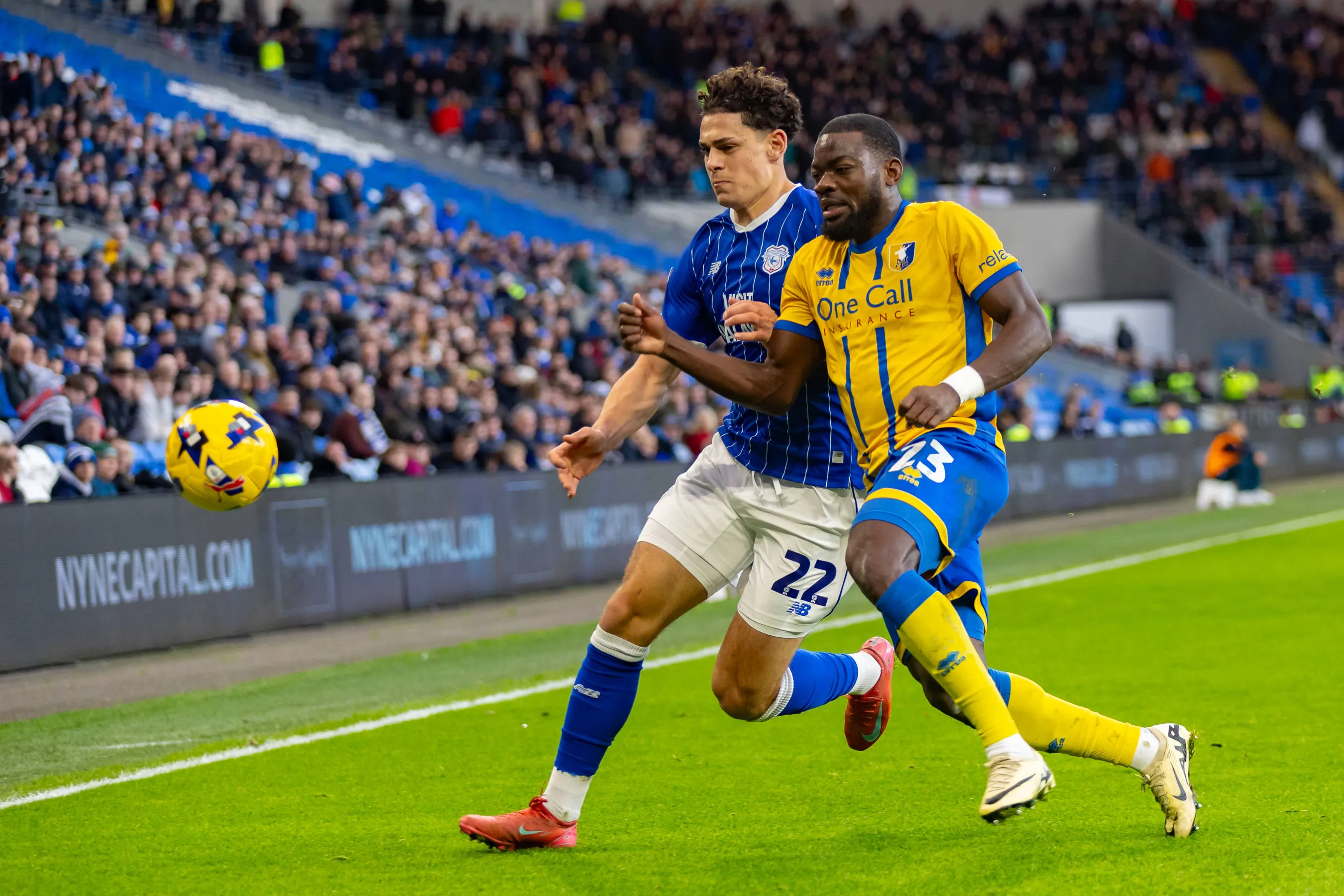 Cardiff City forward Yousef Salech battles for possession with Mansfield Town defender Deji Oshilaja