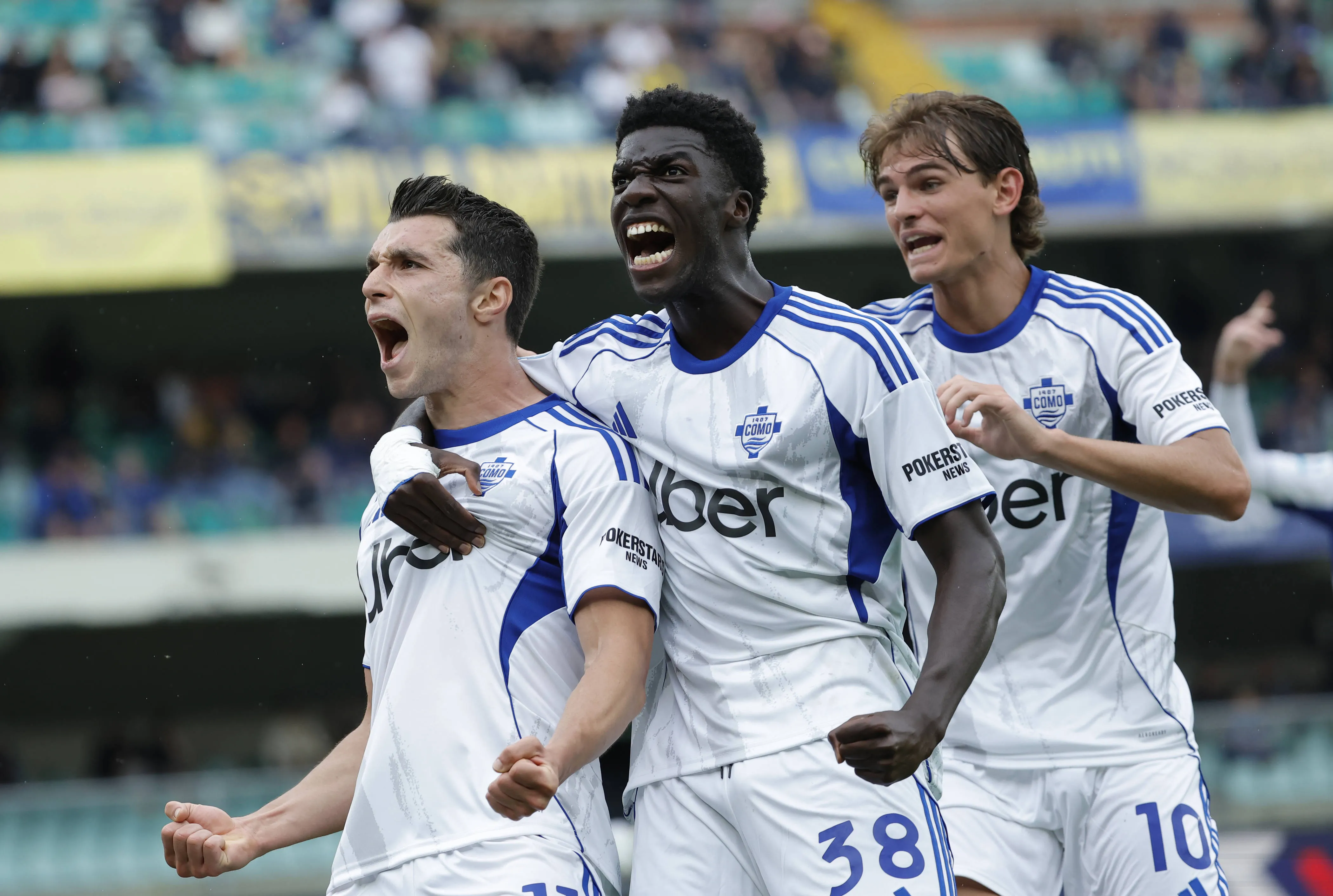 Tasos Douvikas of Como 1907 celebrates with his teammate Assane Diao and Nico Paz during the Italian Serie A soccer match between Hellas Verona FC and Como 1907 at Marcantonio Bentegodi Stadium.