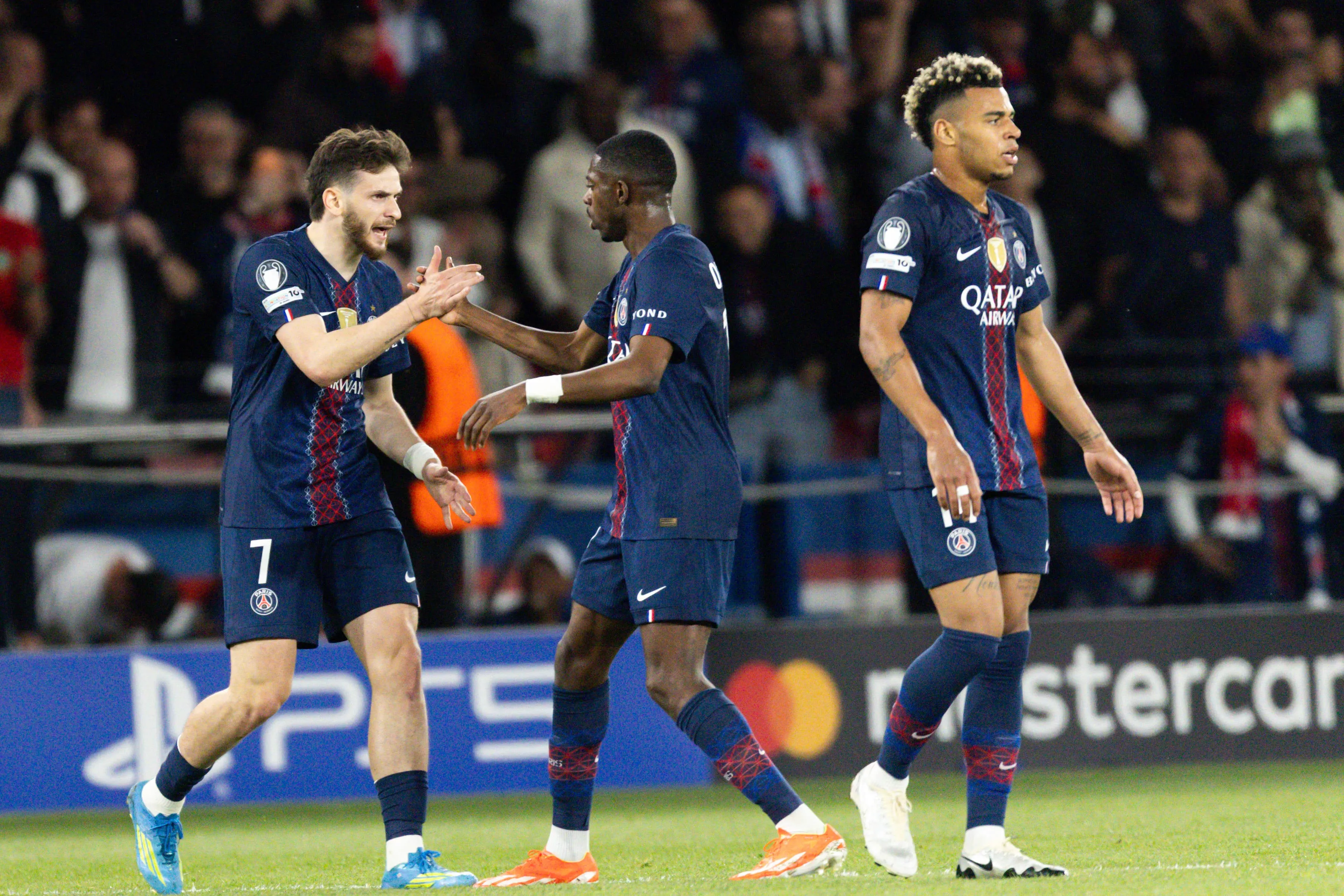Khvicha Kvaratskhelia of Paris Saint-Germain L celebrates with Ousmane Dembele of Paris Saint-Germain R after scoring a goal during the UEFA Champions League semi-final first leg match between Paris Saint-Germain and Bayern Munich. 