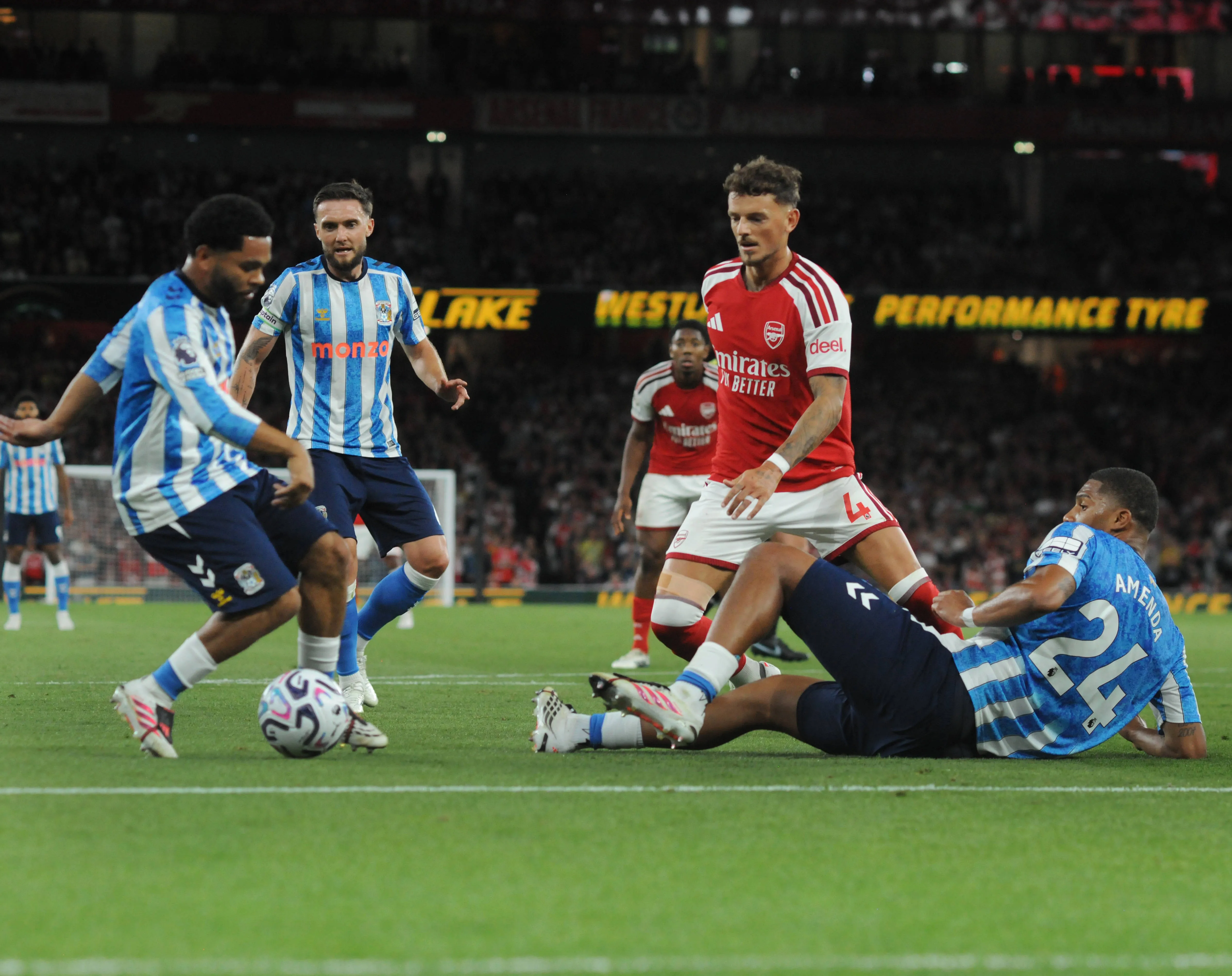 Ben White of Arsenal is challenged by Coventry City players.