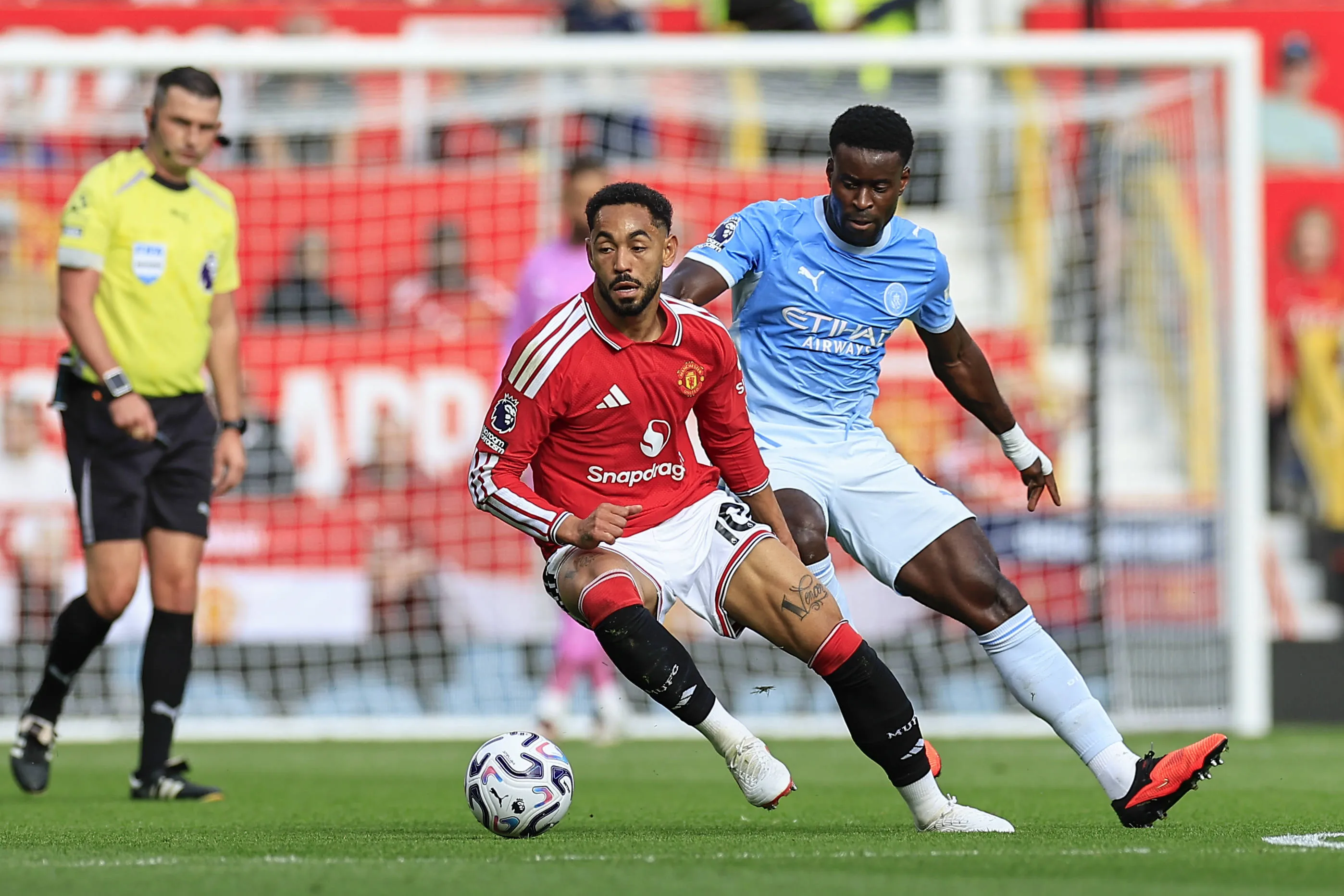 Manchester United's Matheus Cunha and Manchester City's Marc Guehi