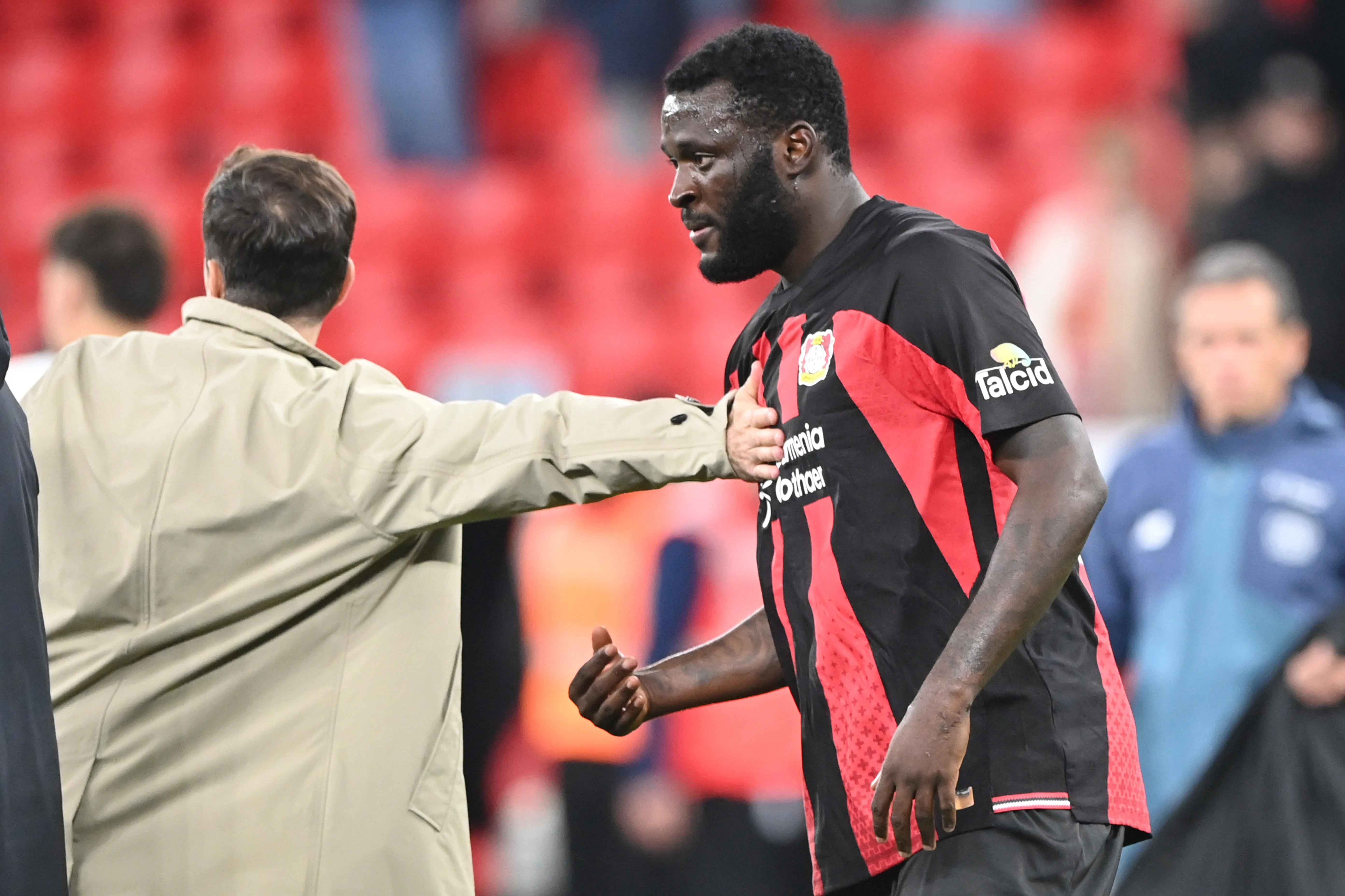 Bayer 04 Leverkusen coach Carles Martinez and Victor Boniface