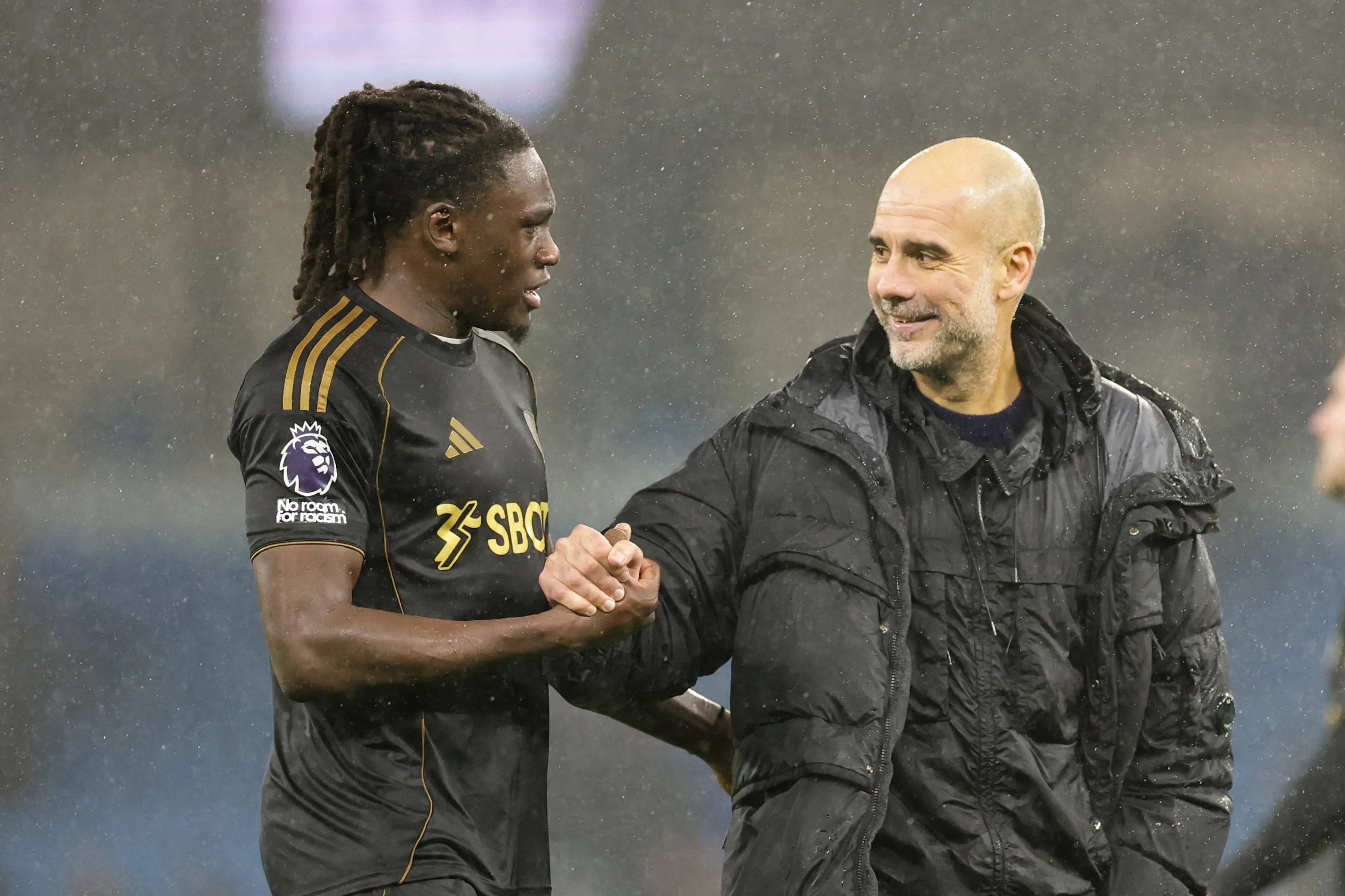 Calvin Bassey shaking Pep Guardiola's hands