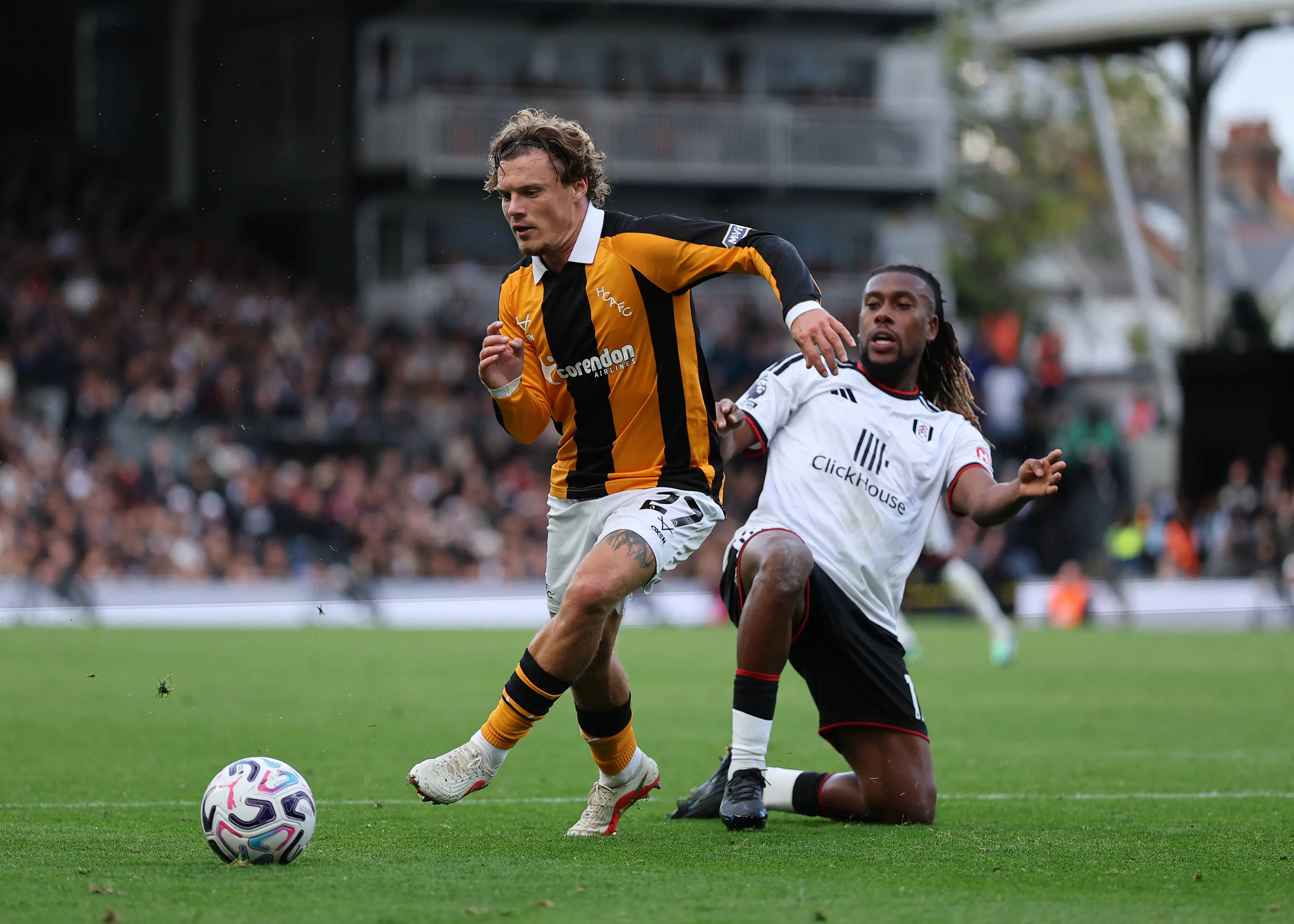 Regan Slater of Hull City under pressure from Alex Iwobi of Fulham