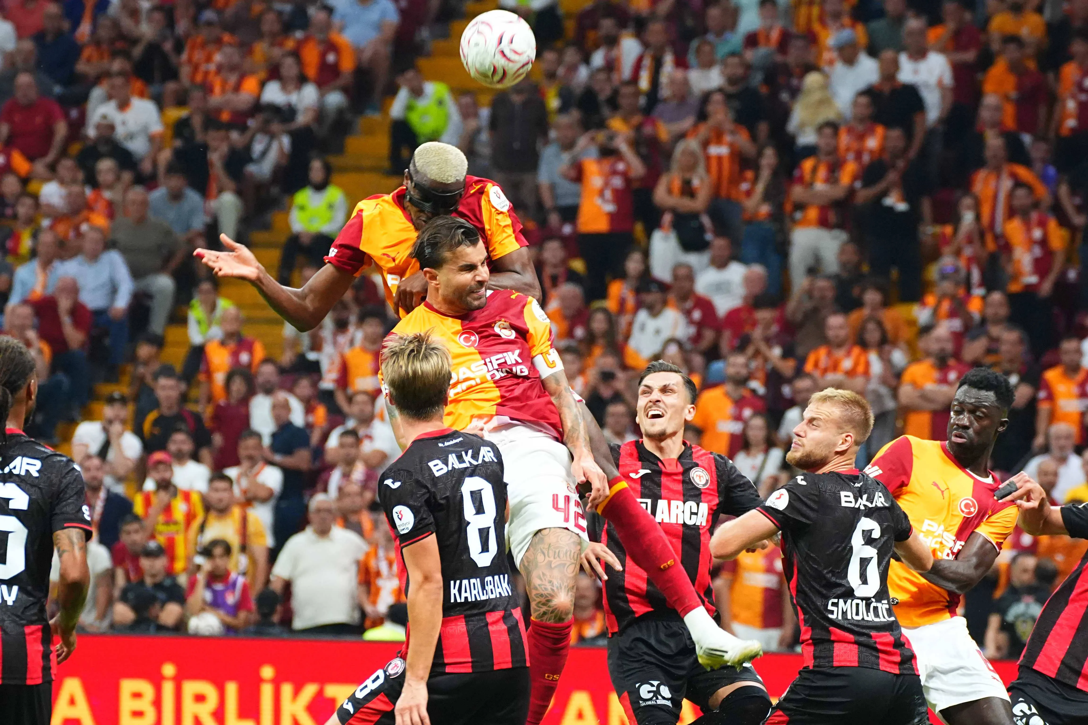 Markus Karlsbakk of Corum FK battles Victor Osimhen in the air