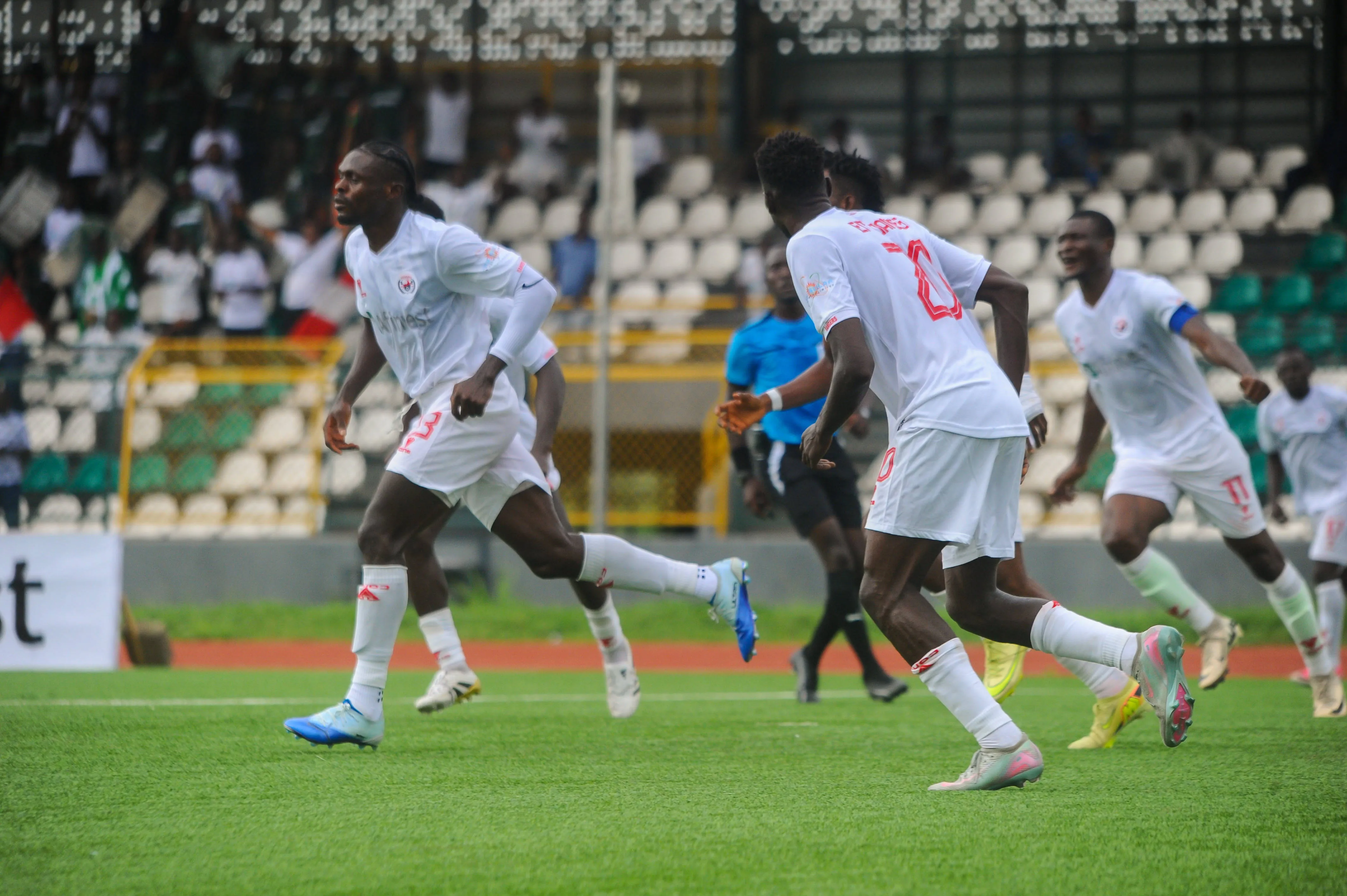 Phanosta Iwundu of Rangers and teammates. 