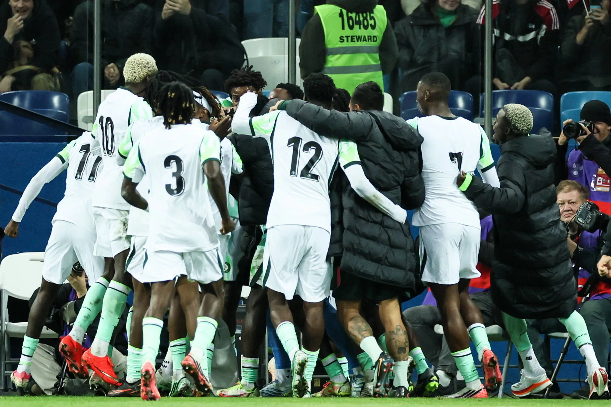 Nigerian players and coaching staff celebrate a goal vs Russia