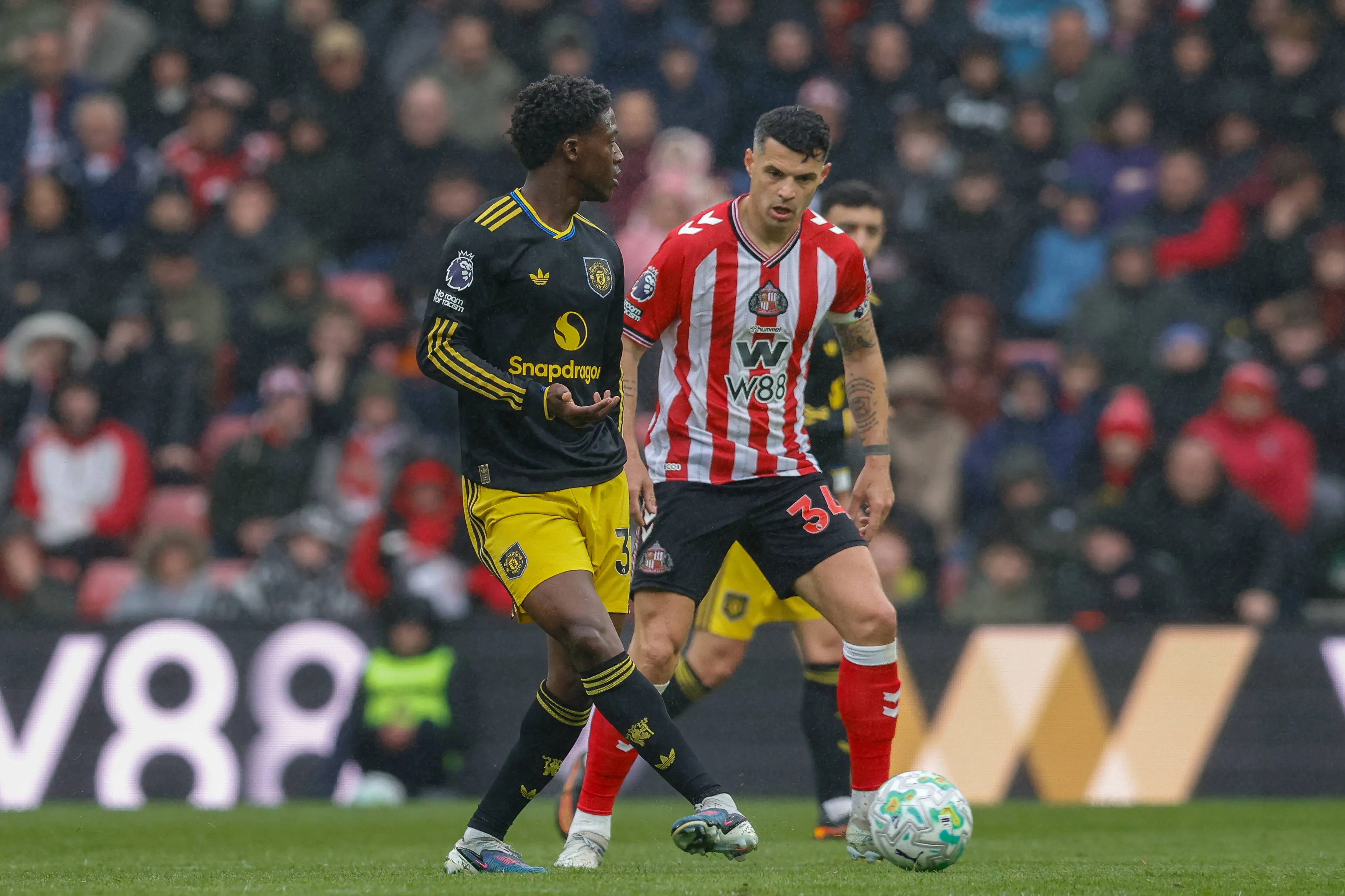 Granit Xhaka of Sunderland closes down Kobbie Mainoo of Manchester United during the Sunderland v Manchester United Premier League match at the Stadium of Light, Sunderland, England on 9 May 2026.