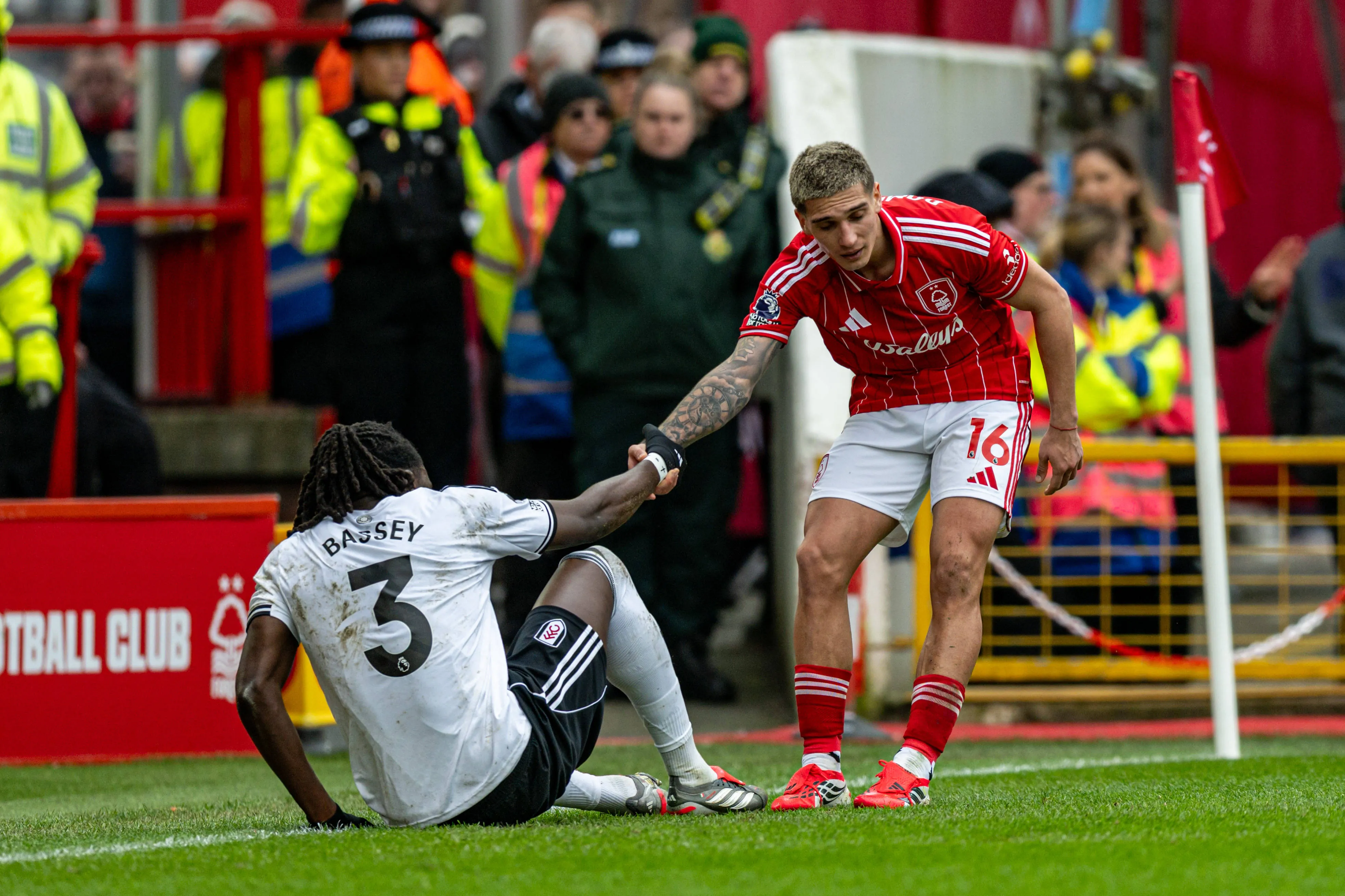 Nicolas Dominguez helps Calvin Bassey to his feet