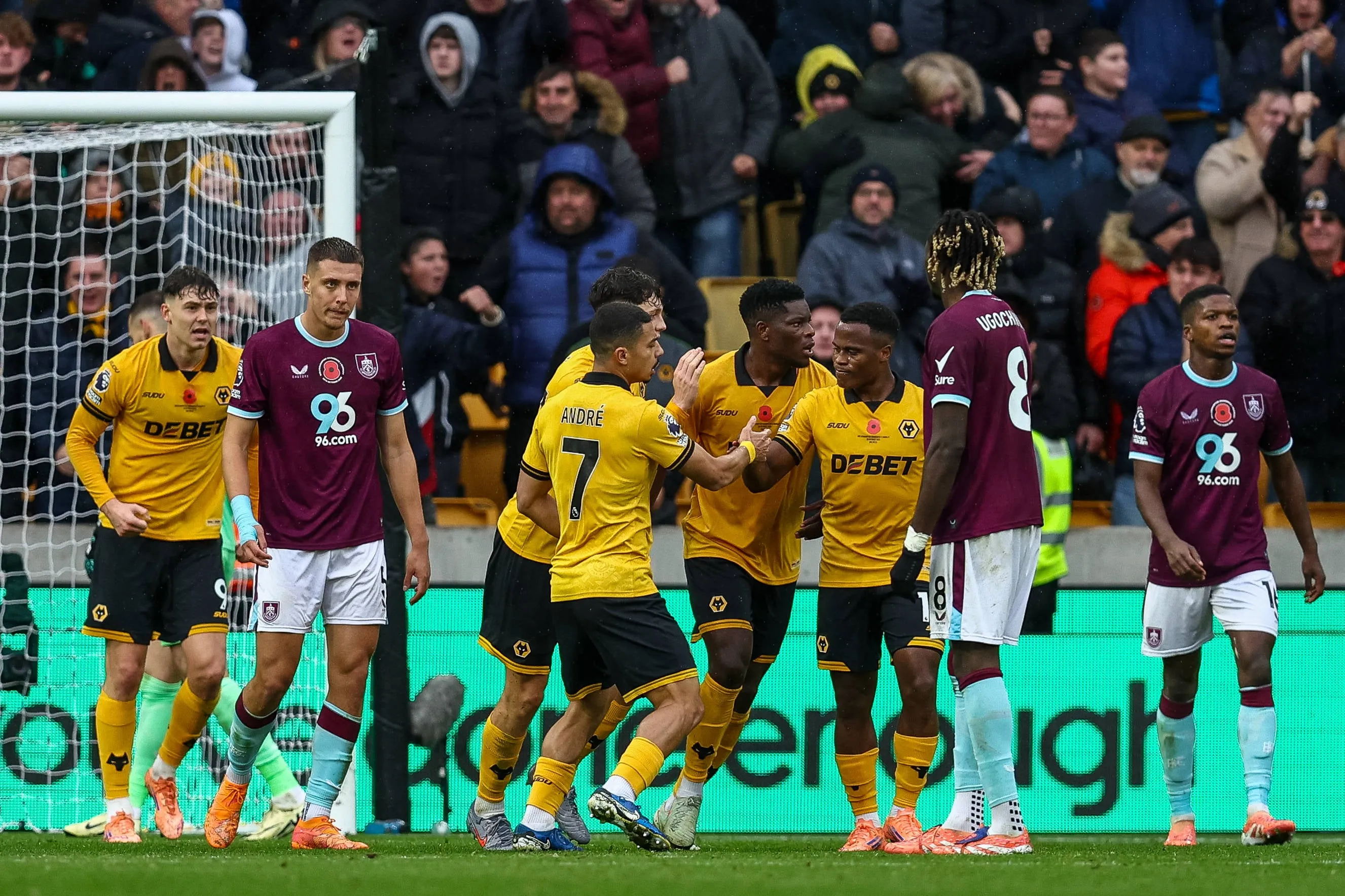 Marshall Munetsi of Wolverhampton Wanderers celebrates the goal with Andre of Wolverhampton Wanderers left and Jhon Arias of Wolverhampton Wanderers right during the Premier League match between Wolverhampton Wanderers and Burnley.