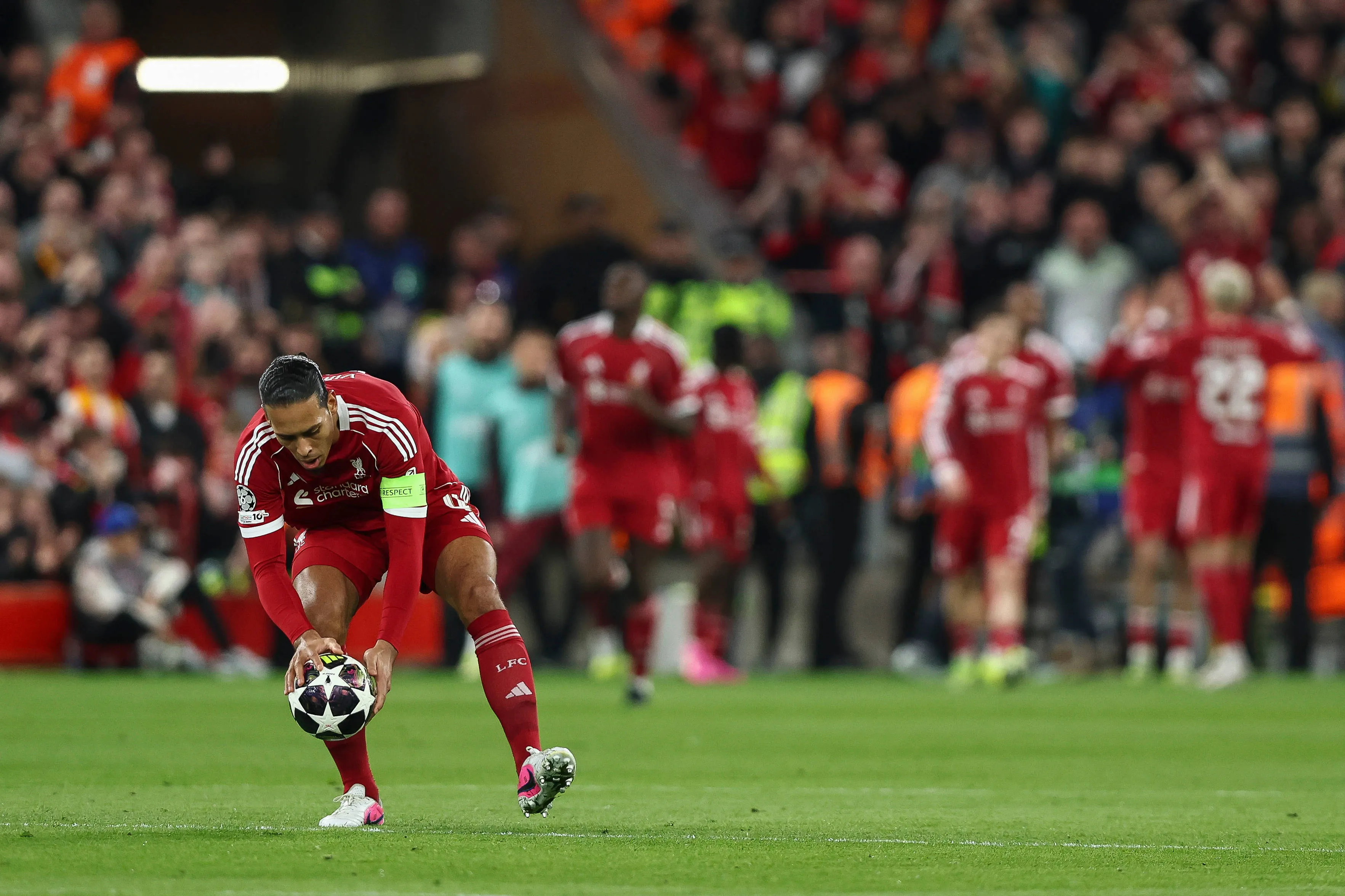 Virgil van Dijk puts the ball on the centre spot during the Liverpool v Galatasaray clash