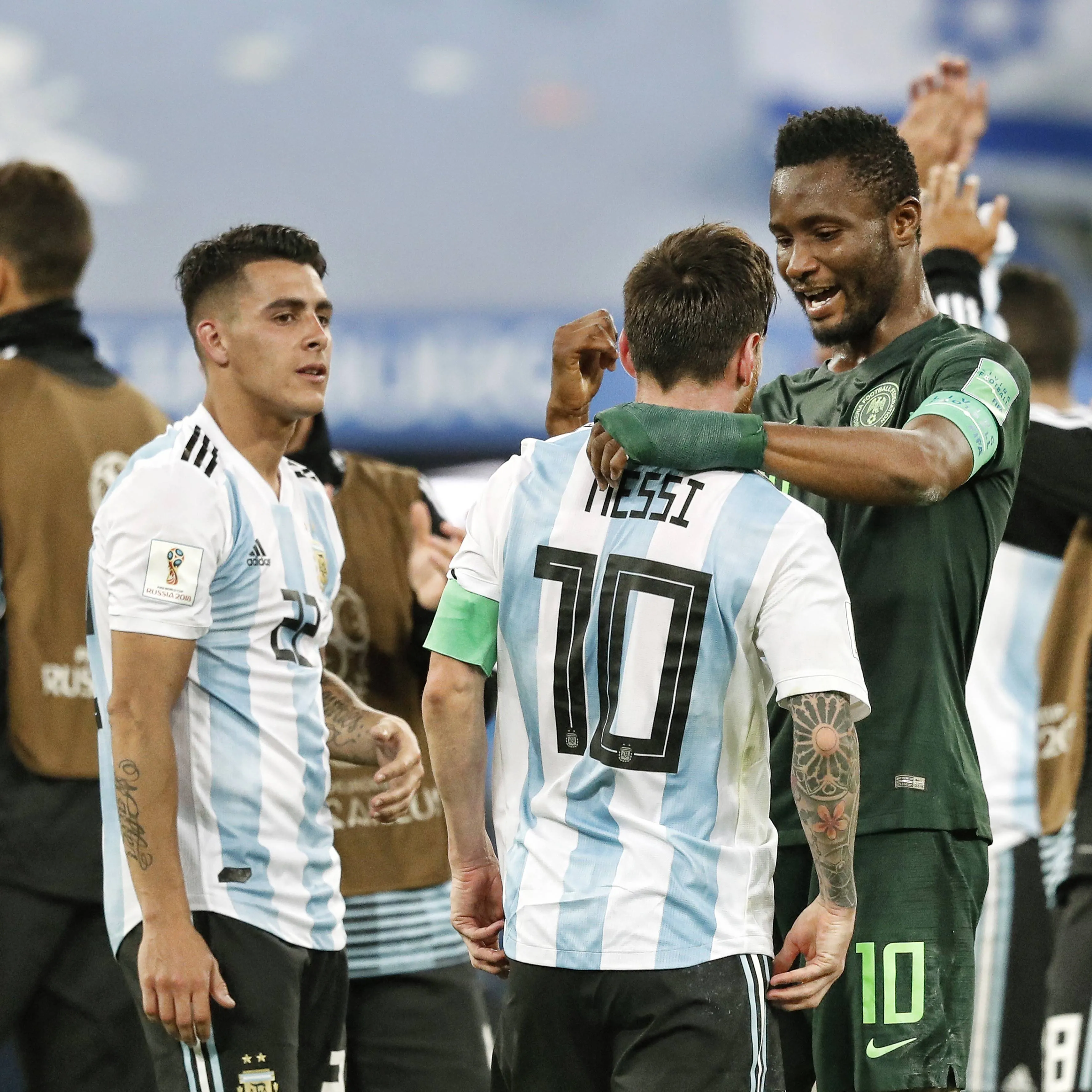 Argentina midfielder Cristian Pavon (L) Argentina forwarder Lionel Messi (C) and Nigeria midfielder John Obi Mikel (R)