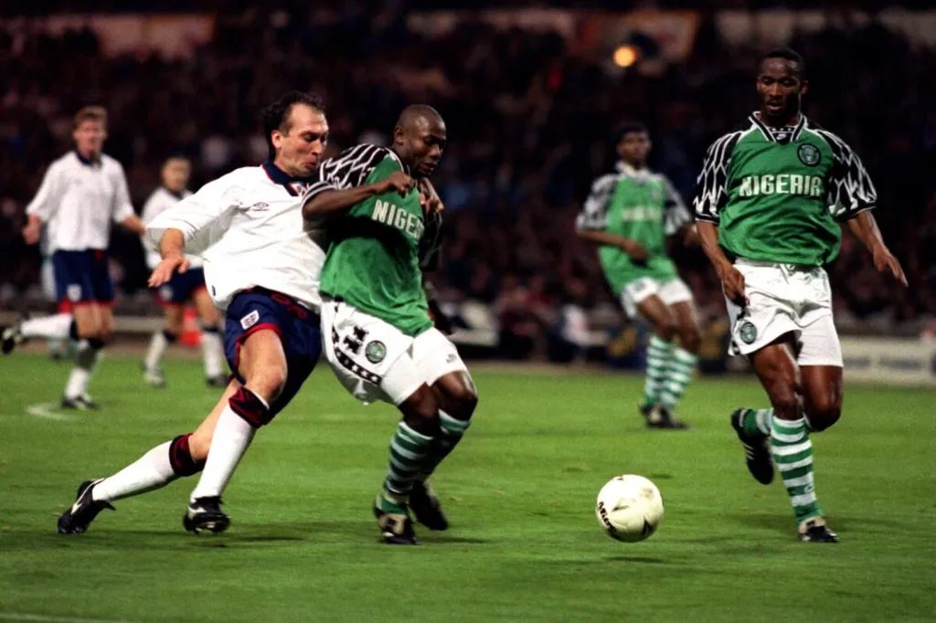 David Platt contends for the ball with Emmanuel Amunike