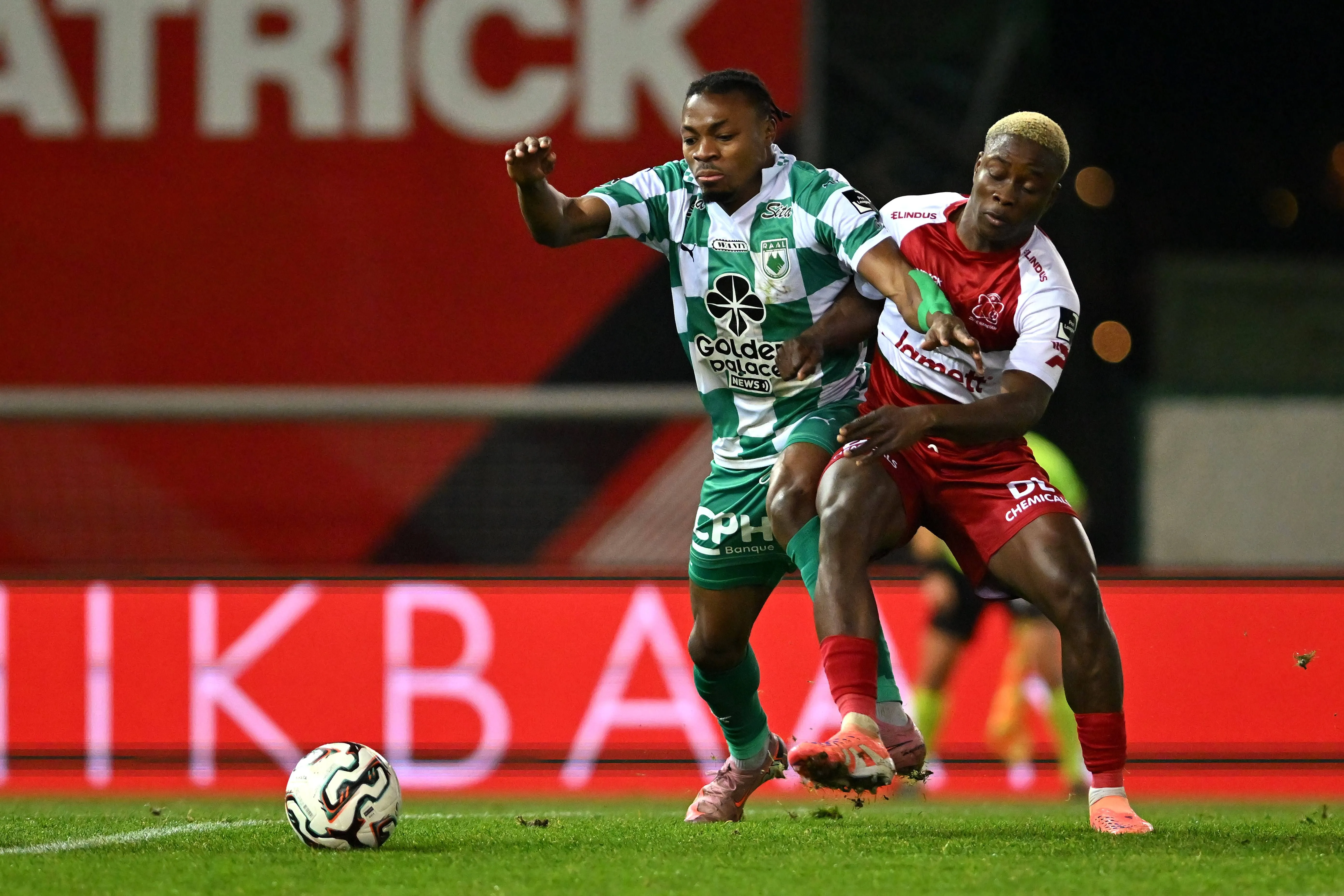 Tochukwu Nnadi fight for the ball during a soccer match between SV Zulte Waregem and RAAL La Louviere