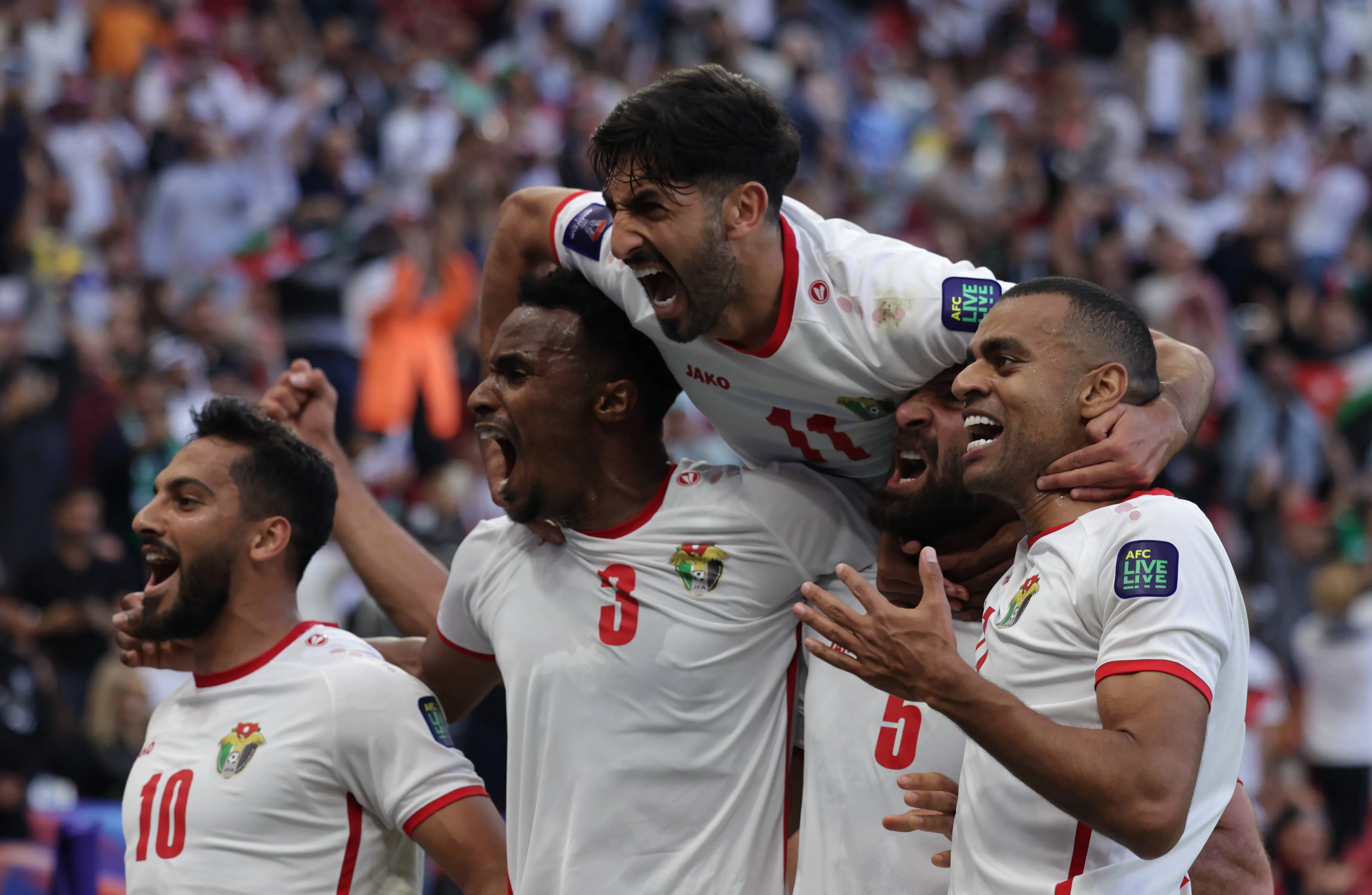Jordan's Yazan Al-Arab celebrates with Musa Al-Taamari, Abdallah Nasib, Yazan Al-Naimat