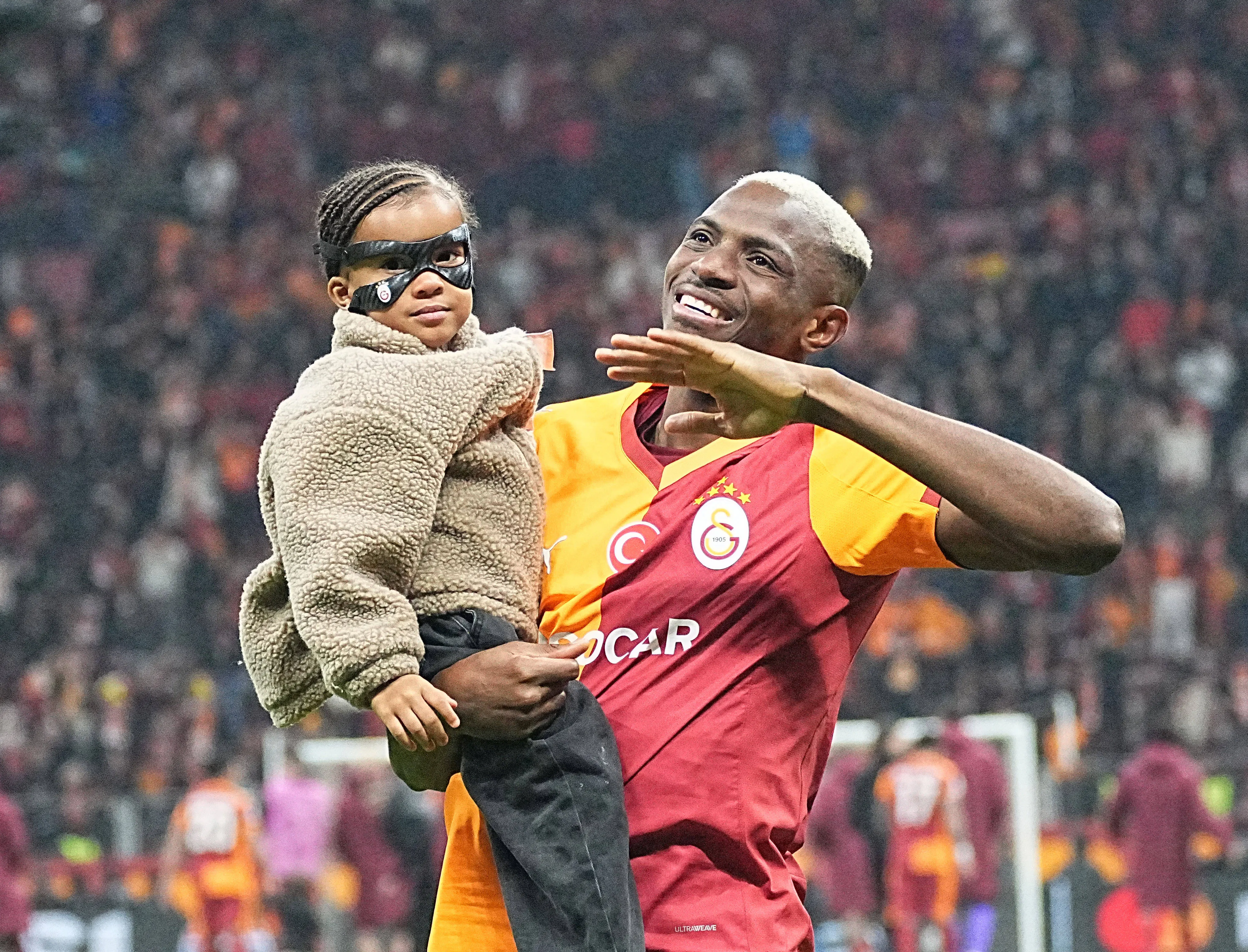 Victor Osimhen of Galatasaray and his daughter Hailey celebrates victory with fans