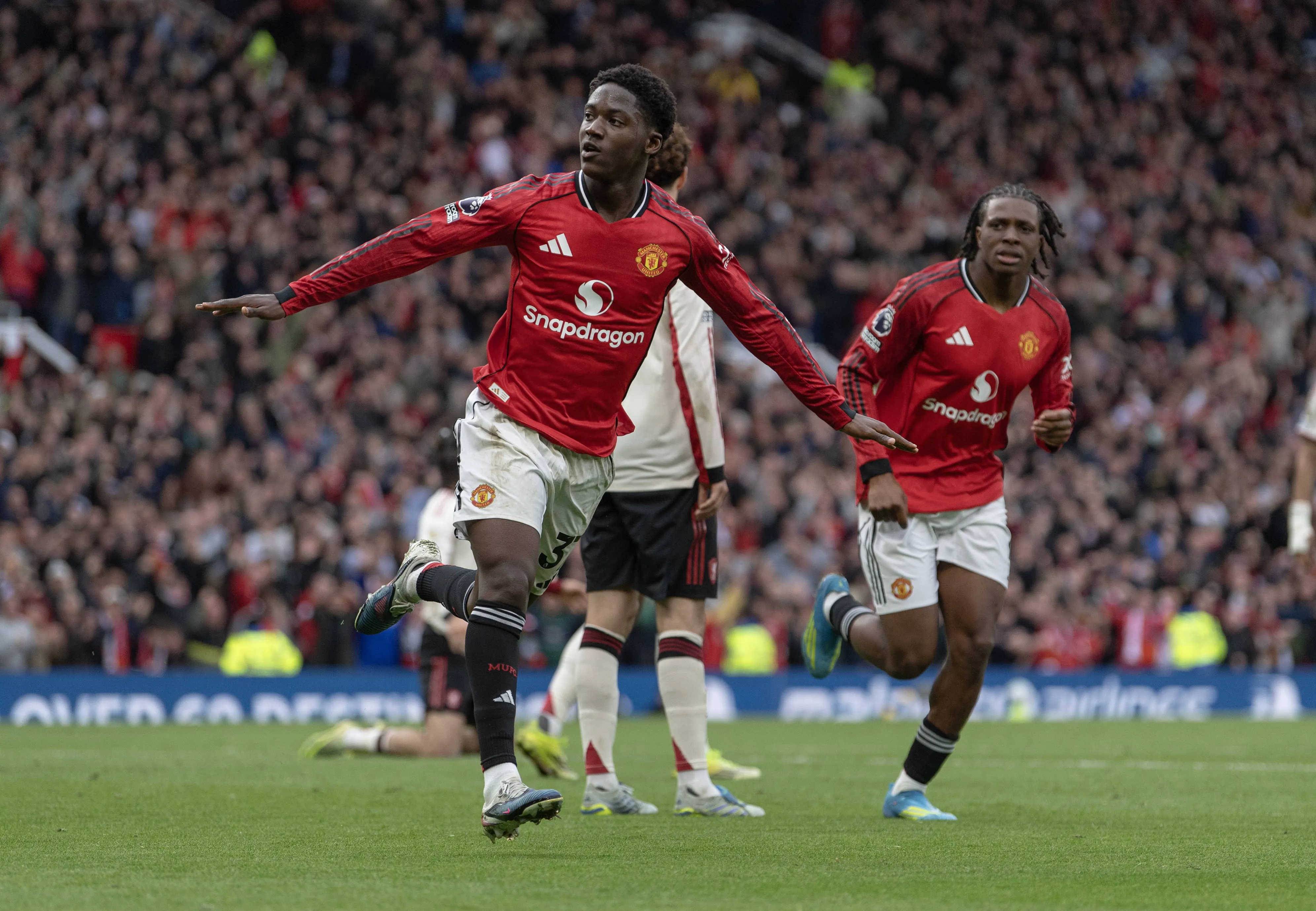 Kobbie Mainoo celebrates scoring the third goal during the Premier League match between Manchester United and Liverpool