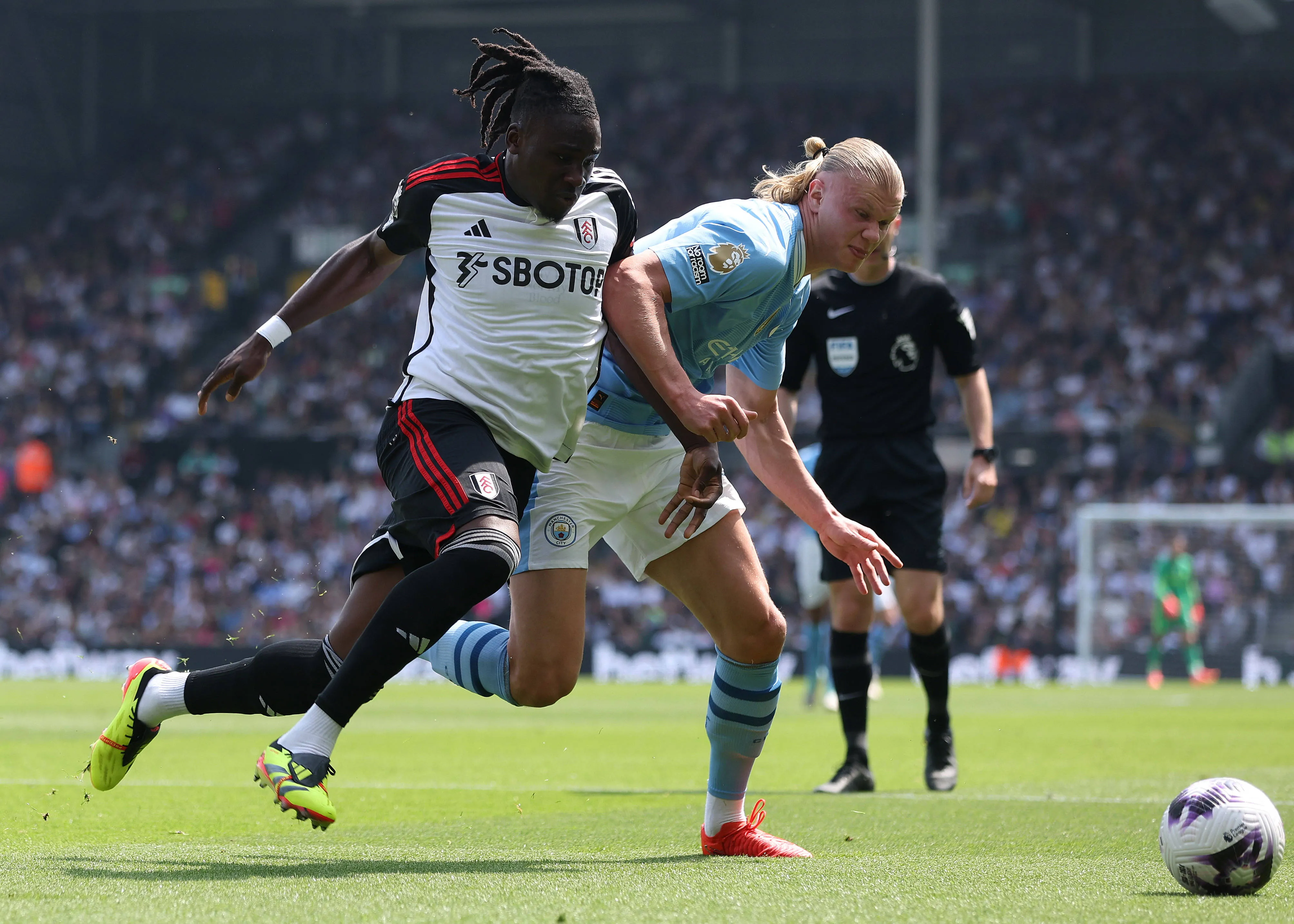 Calvin Bassey of Fulham and Erling Haaland of Manchester City