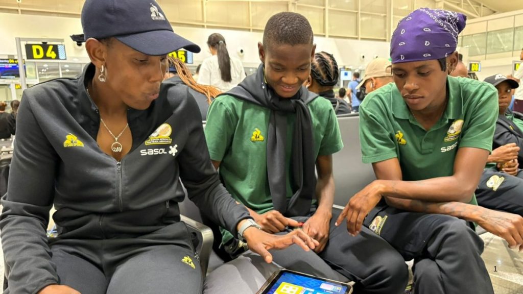Banyana Banyana players relax at airport.