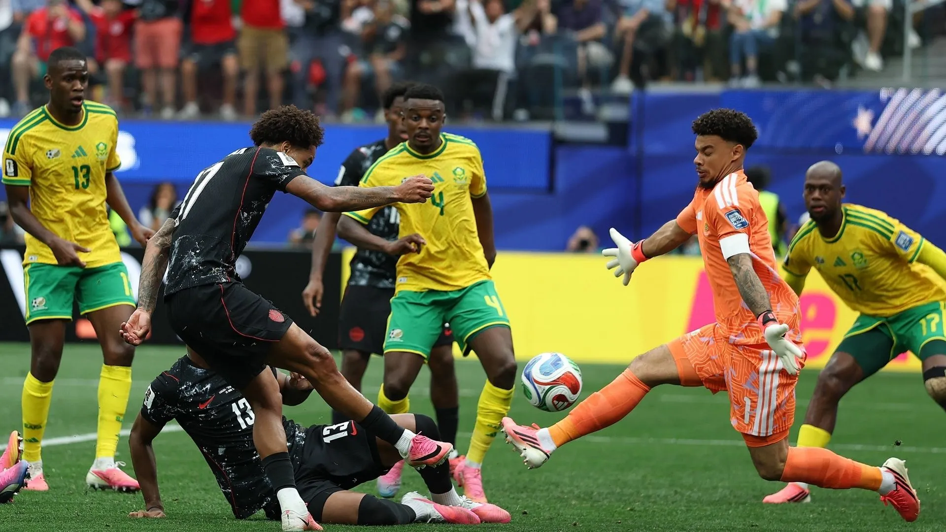 South Africa goalkeeper Ronwen Williams keepers out an effort from Tajon Buchanan of Canada.