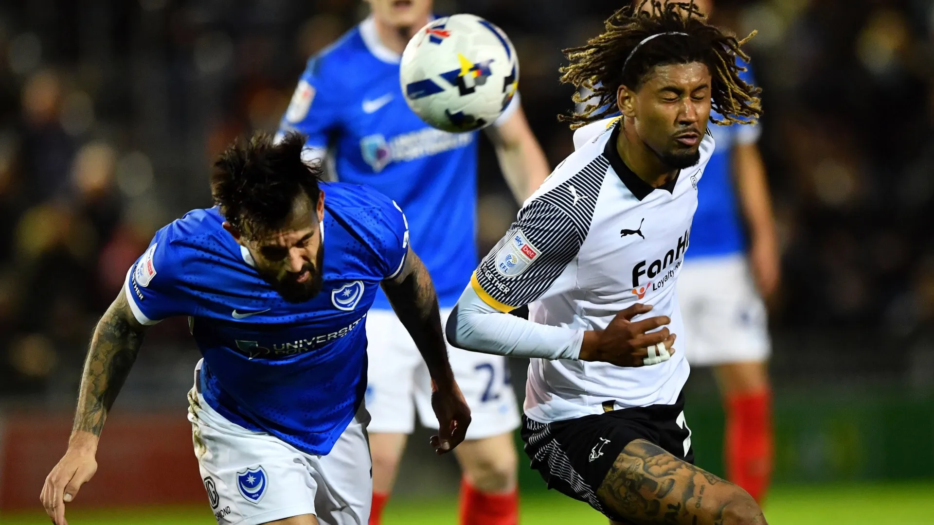 Marlon Pack of Portsmouth and Dion Sanderson of Derby County challenge for the ball