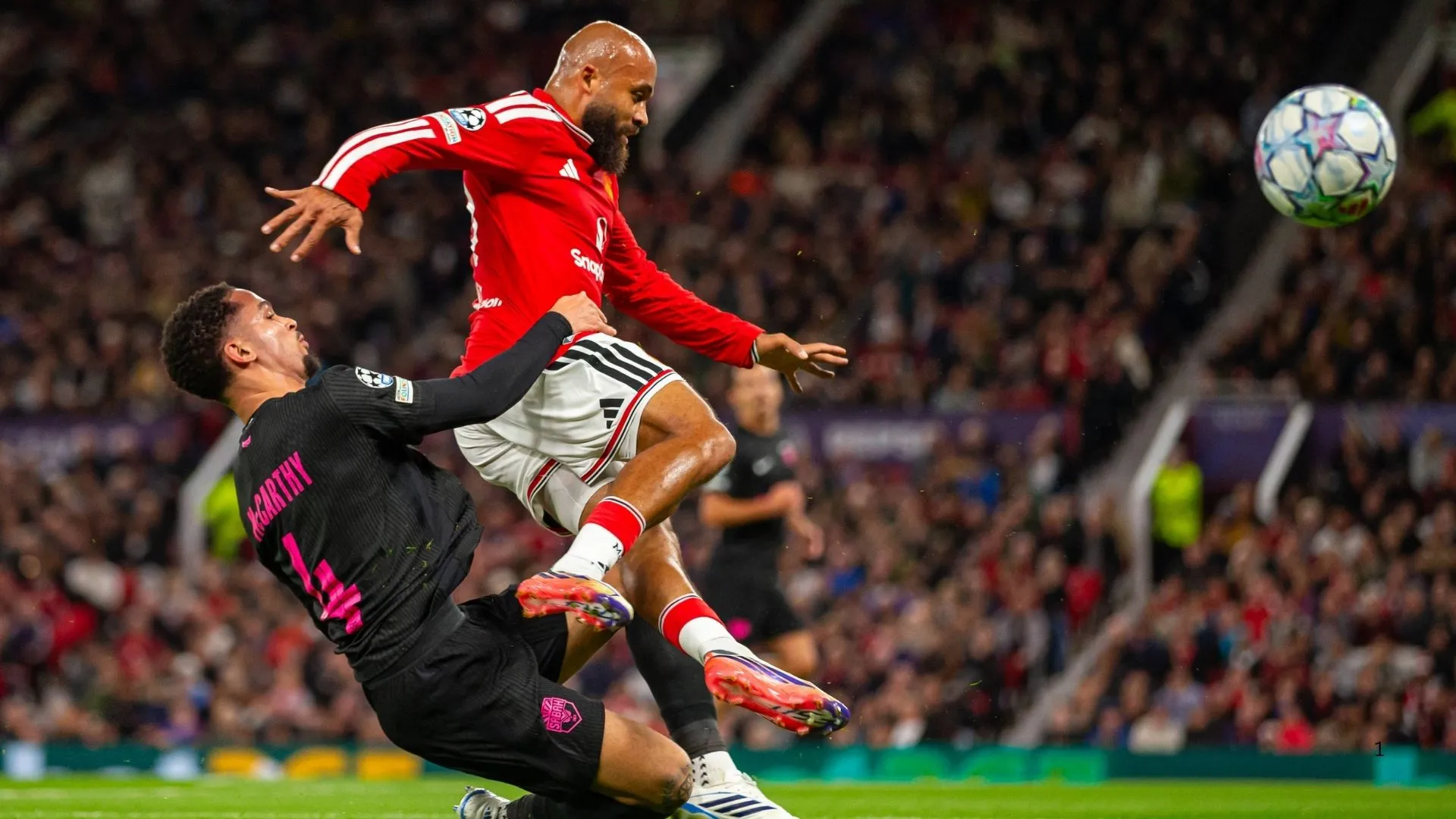 Aden McCarthy of Sabah FK tackling Manchester United's Bryan Mbeumo.