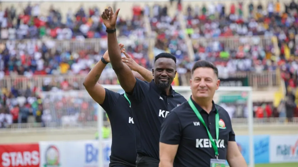 Harambee Stars coaching beanch salutes fans after defeat to Gabon. Photo – FKF