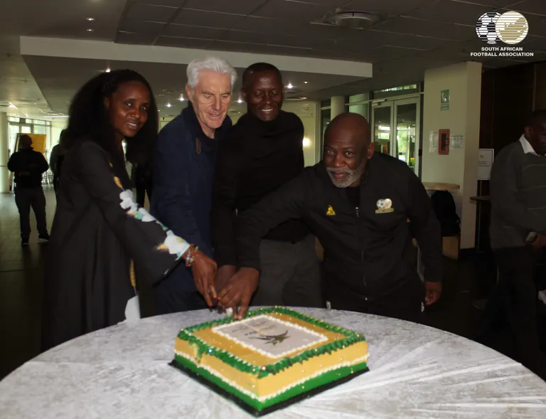 Vincent Tseka cuts his cake and eats it celebrating Bafana Bafana’s World Cup qualification