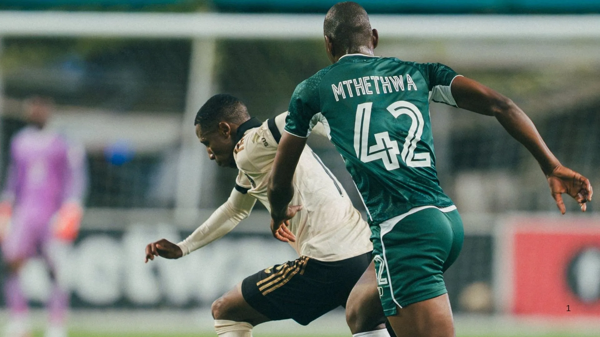 Tshepang Moremi of Orlando Pirates is challenged by Sandile Mthethwa of AmaZulu FC.