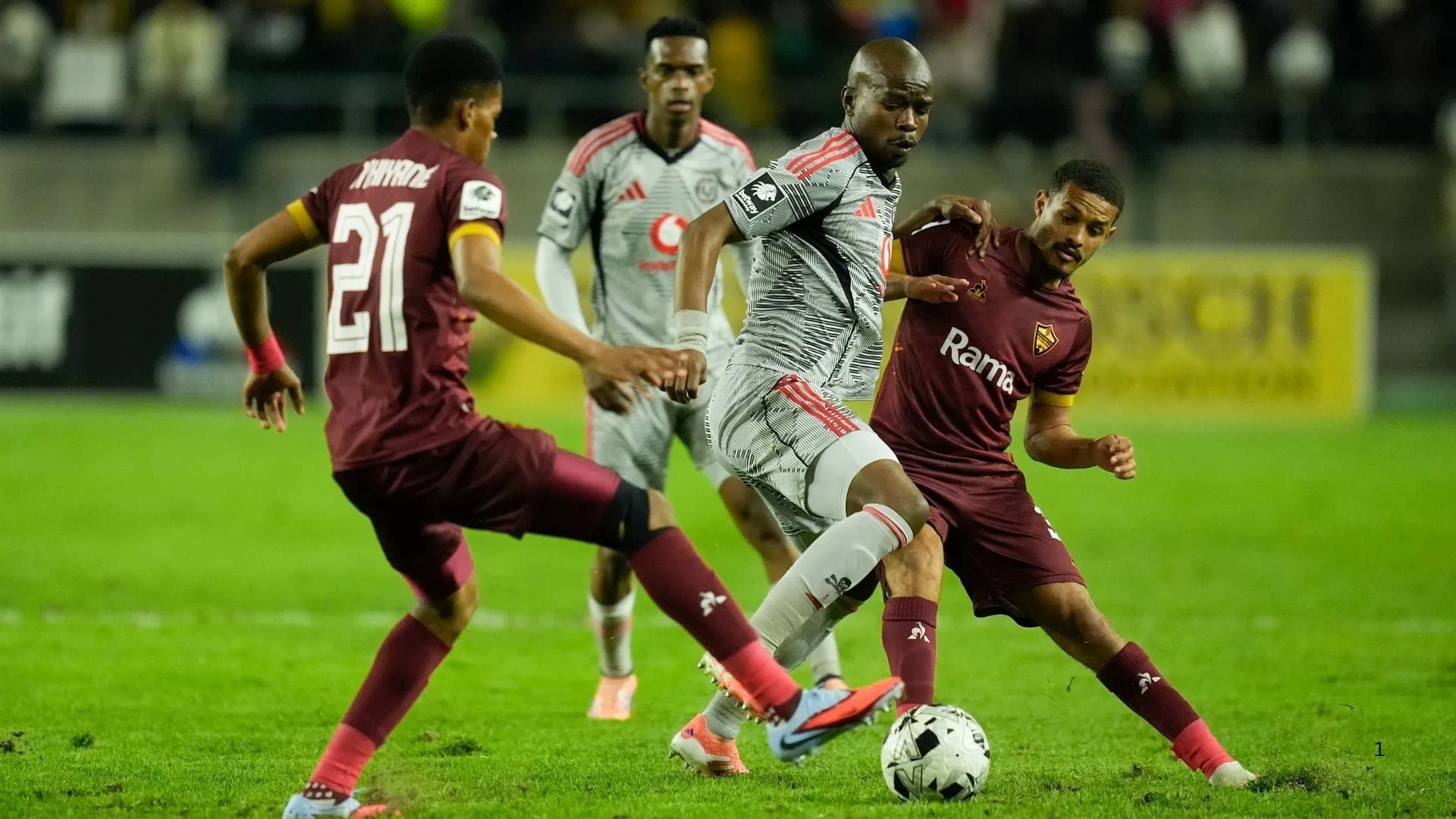 Nkosinathi Sibisi of Orlando Pirates vies for the ball with Devin Titus of Stellenbosch FC.