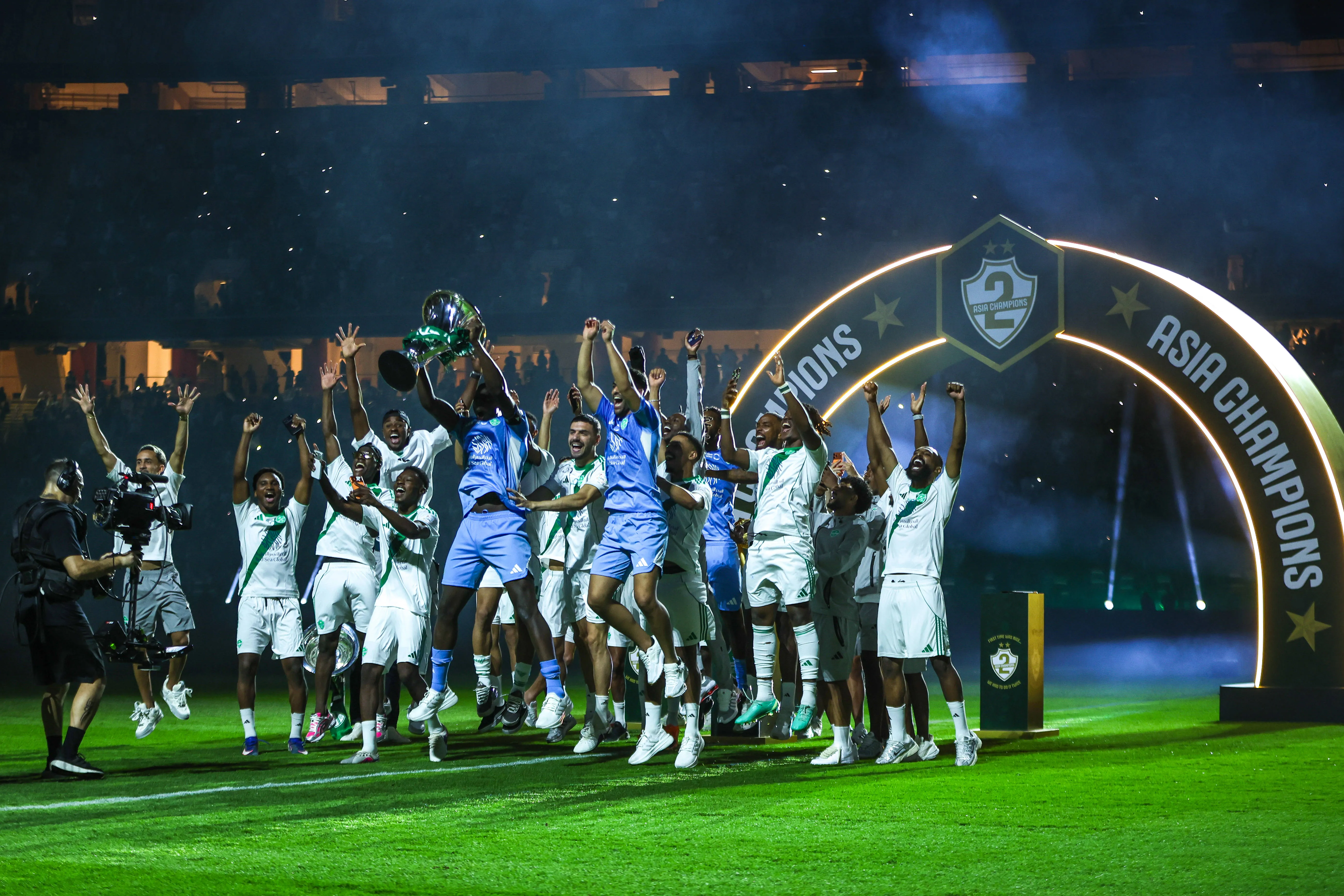 Saudi Pro League Al Ahly team celebrates with three cups