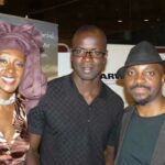 De gauche à droite, une charmante convive, le champion du monde Lilian Thuram et l'acteur Emile Abossolo M'Bo